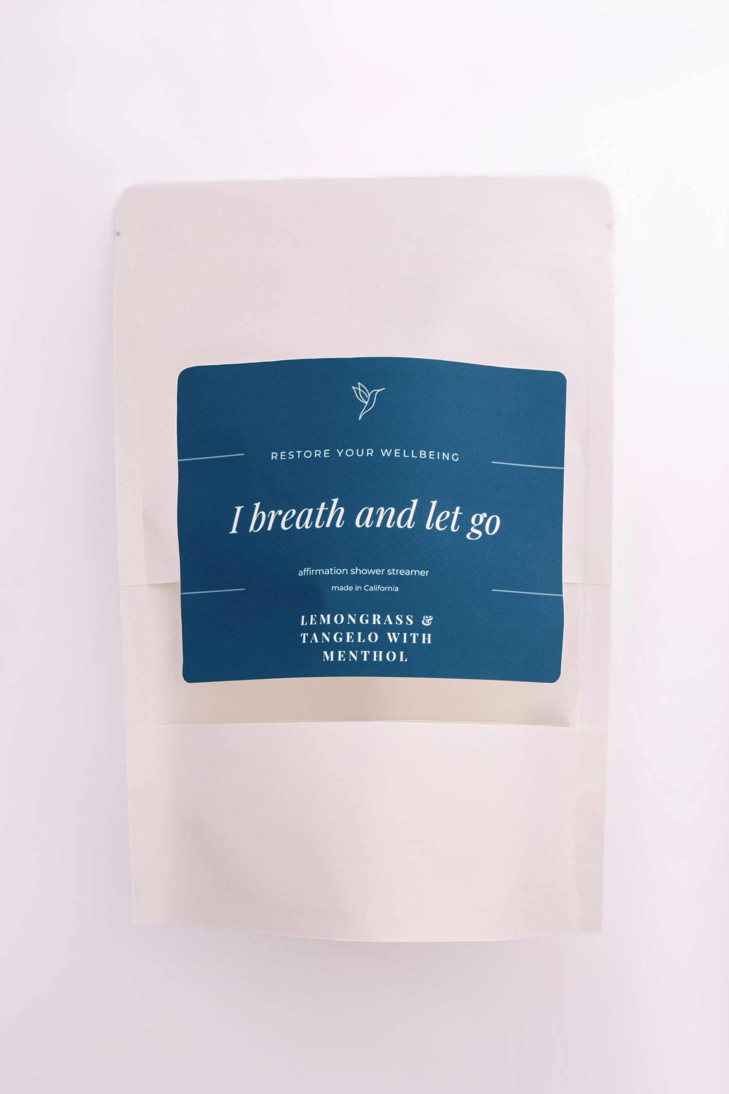 Minimalist blue and white product label with 'I breath and let go' text and wellness branding.