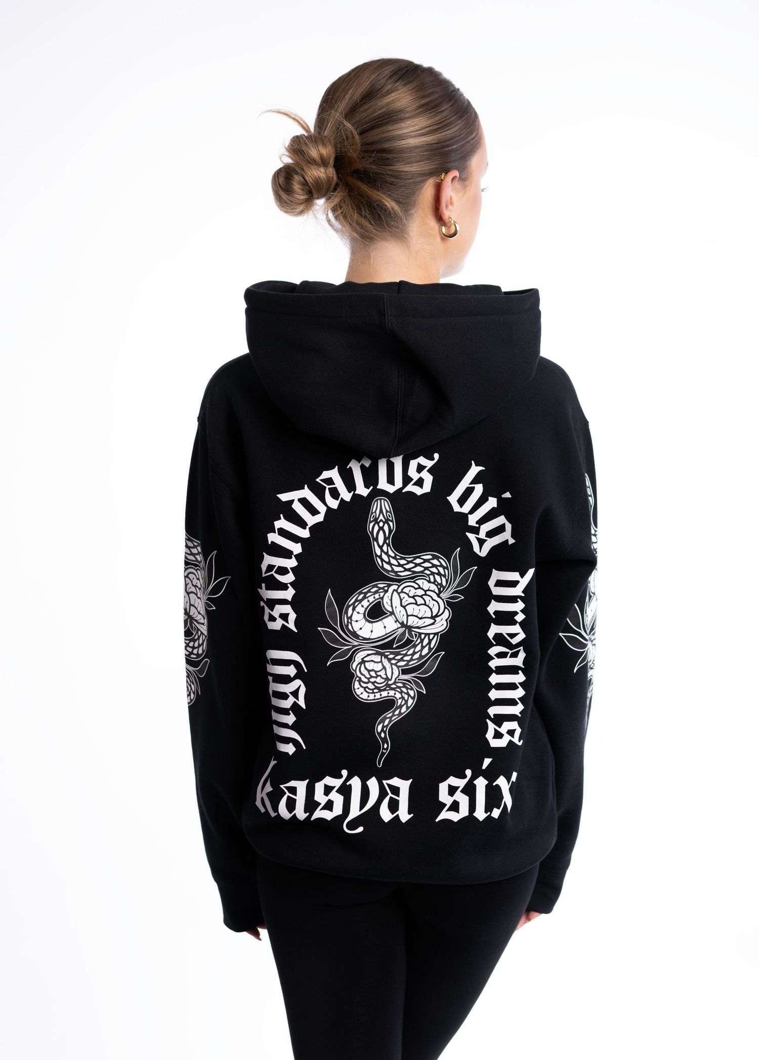 Back view of black hoodie with white snake graphic and 'high standards big dreams kasya six' text print.