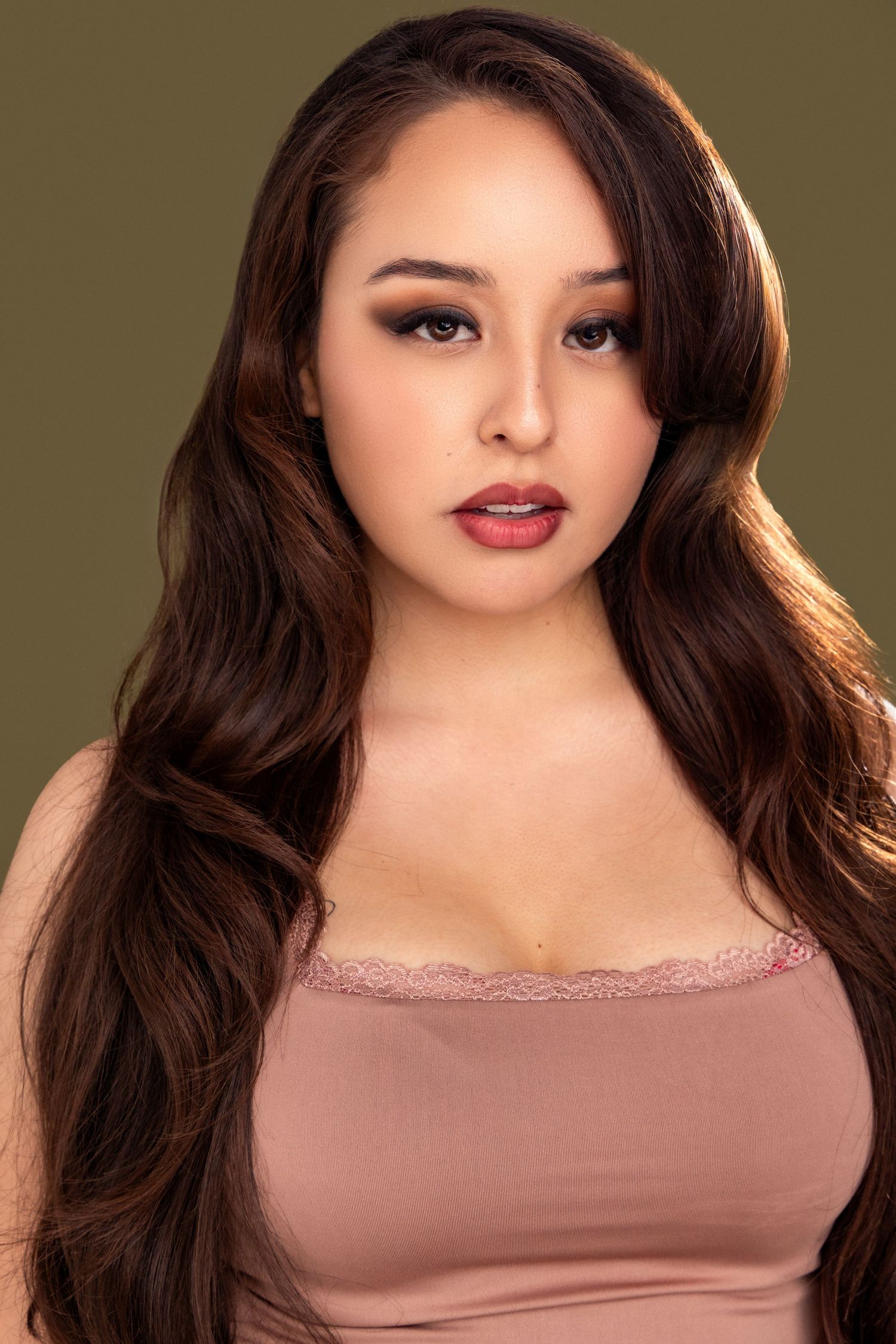 Portrait series showing a woman with long dark hair wearing a mauve top against an olive green background.