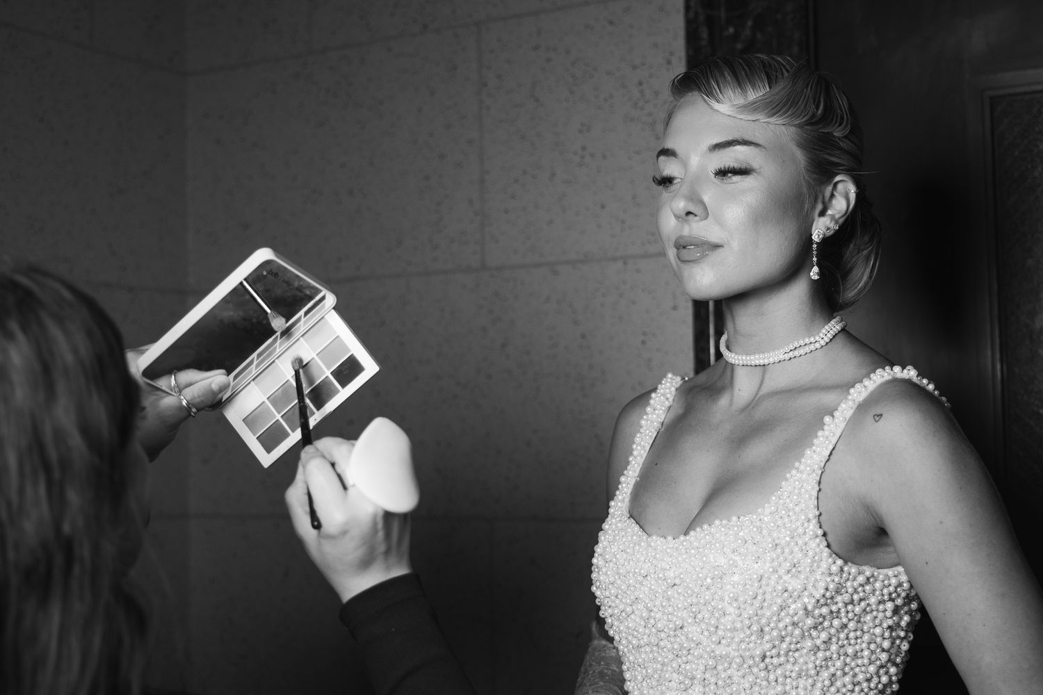 Black and white photos showing someone in a beaded dress holding polaroid photographs.