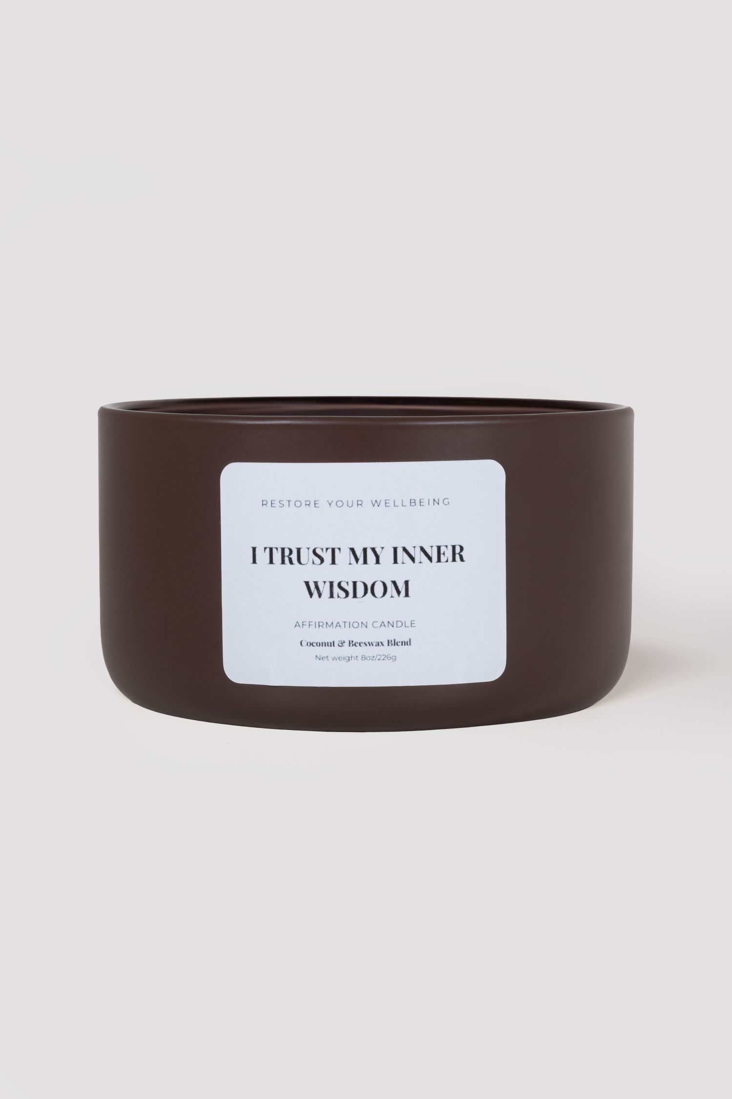 Dark brown ceramic affirmation candle reading I Trust My Inner Wisdom, coconut and beeswax blend.