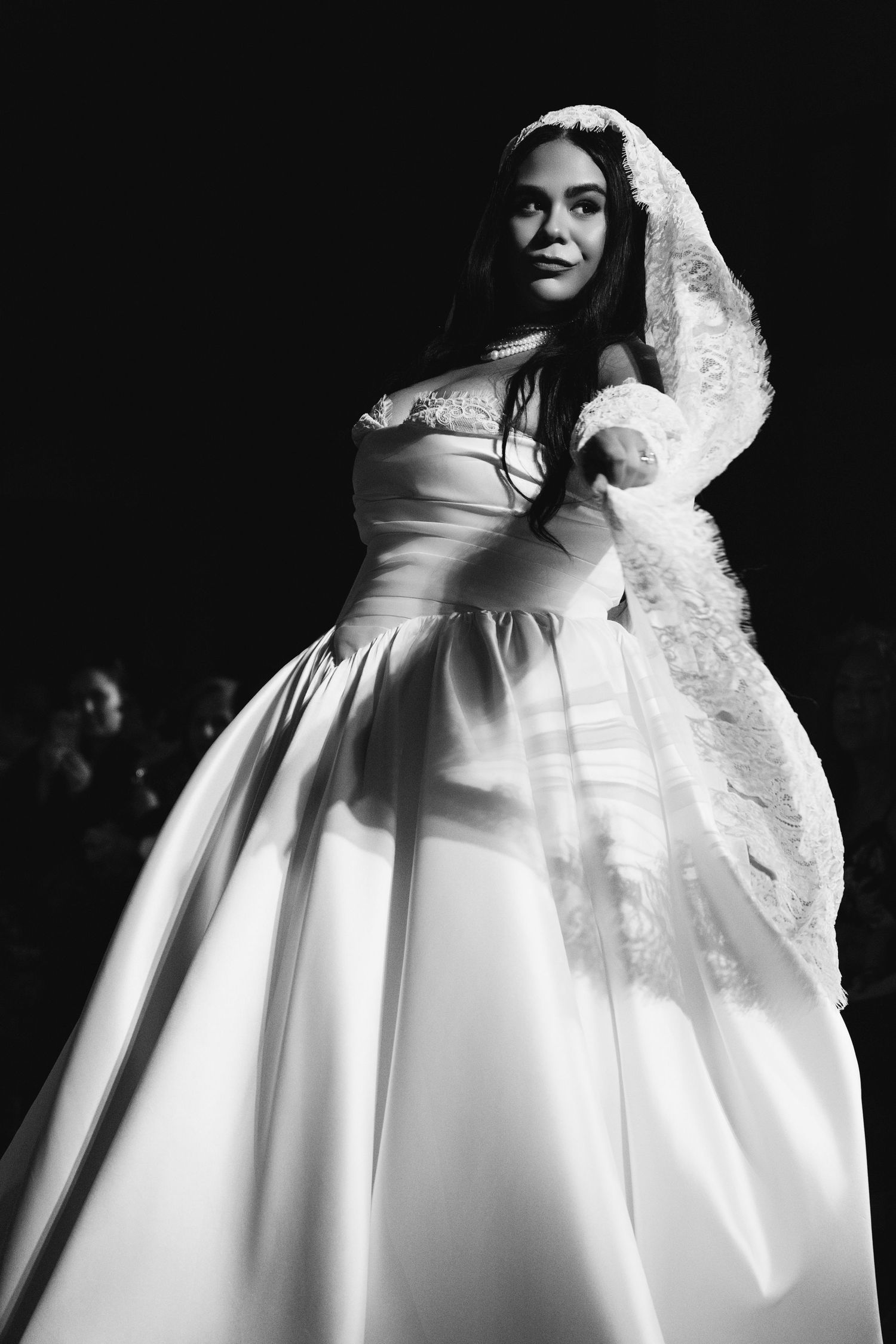 Artistic black and white bridal portrait featuring a voluminous white ball gown with structured bodice.