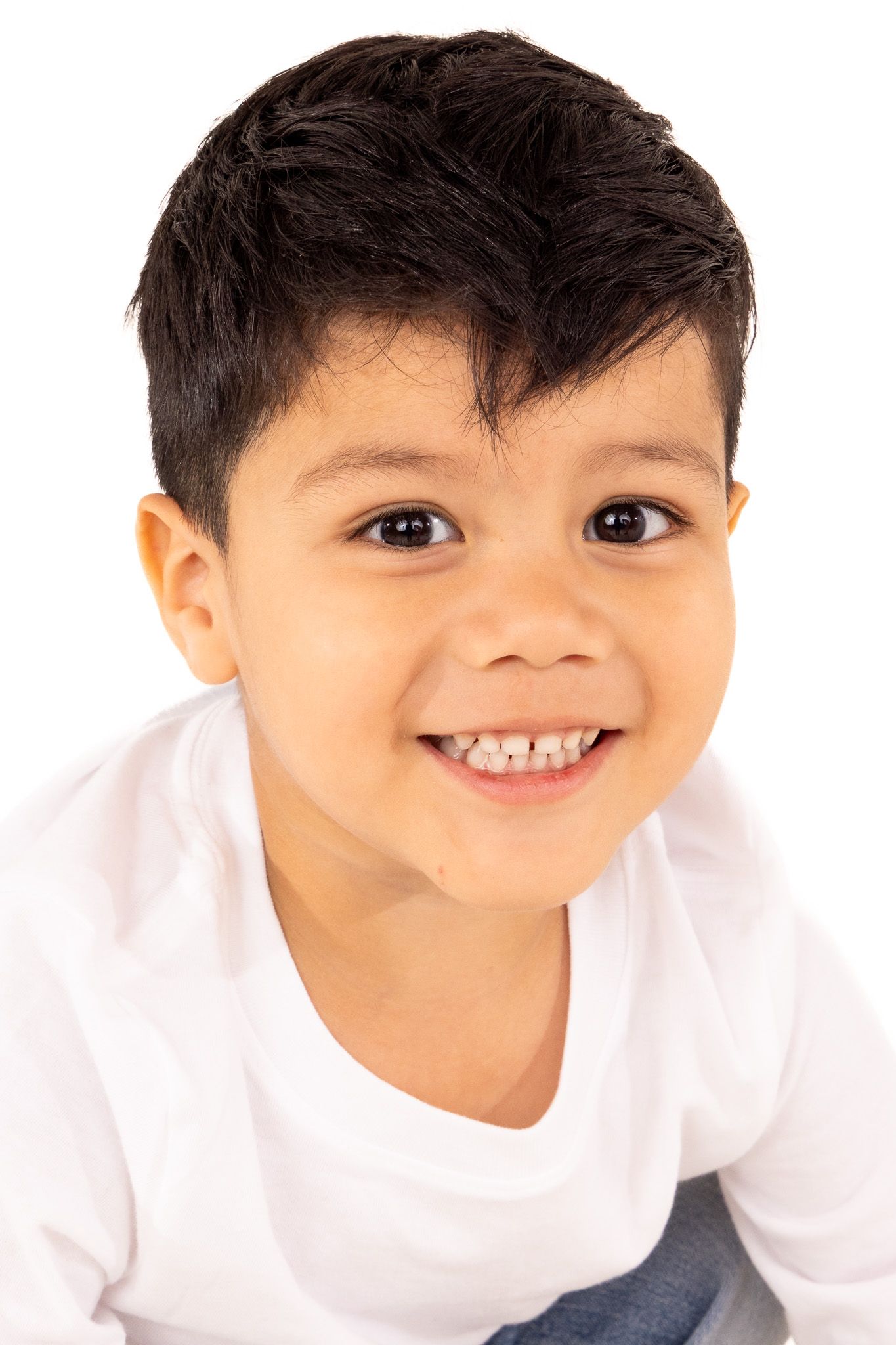 Child in white t-shirt showing bright smile in series of close-up portraits.
