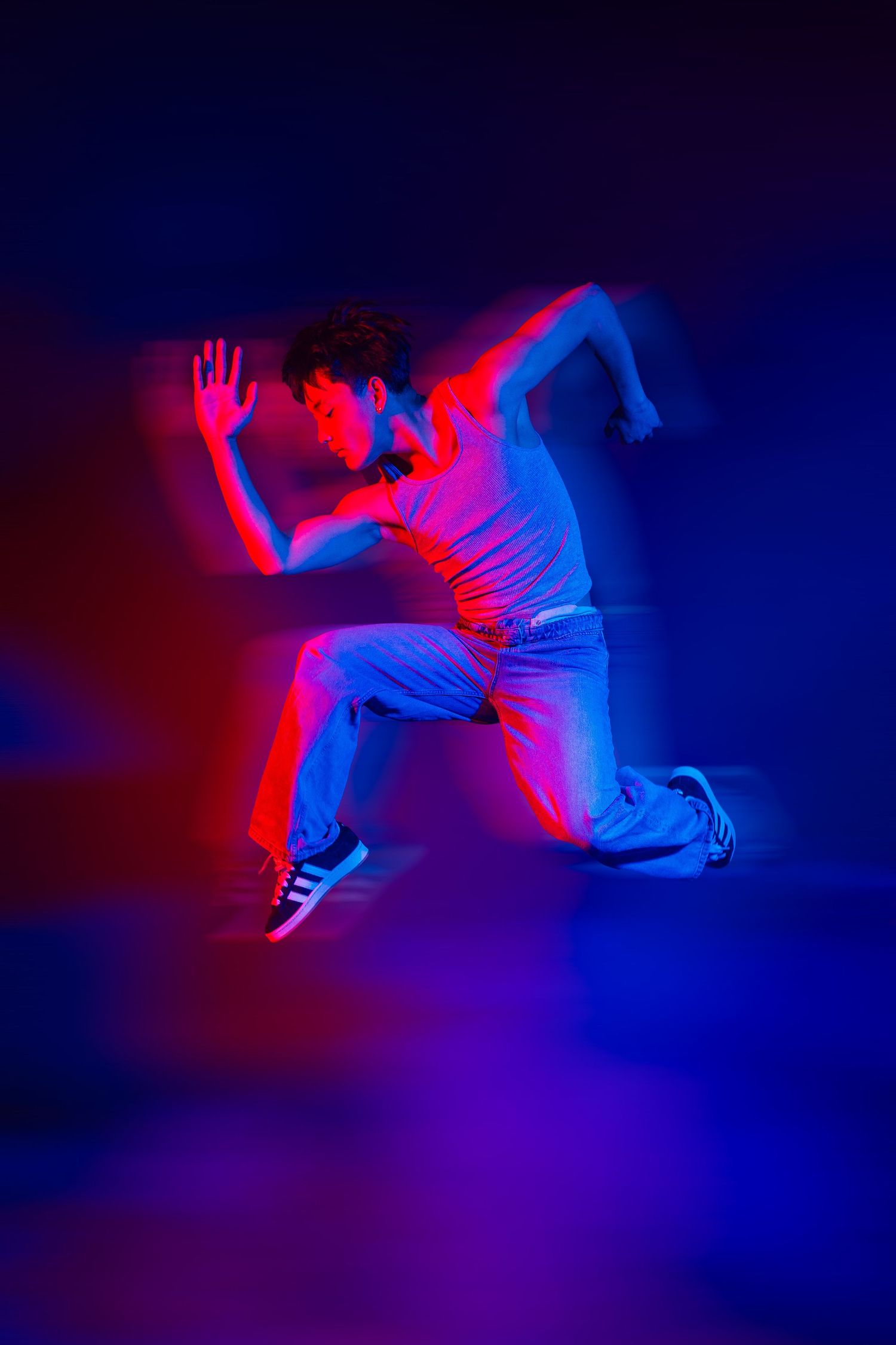 Athletic figure frozen mid-motion under dramatic neon lighting effects.