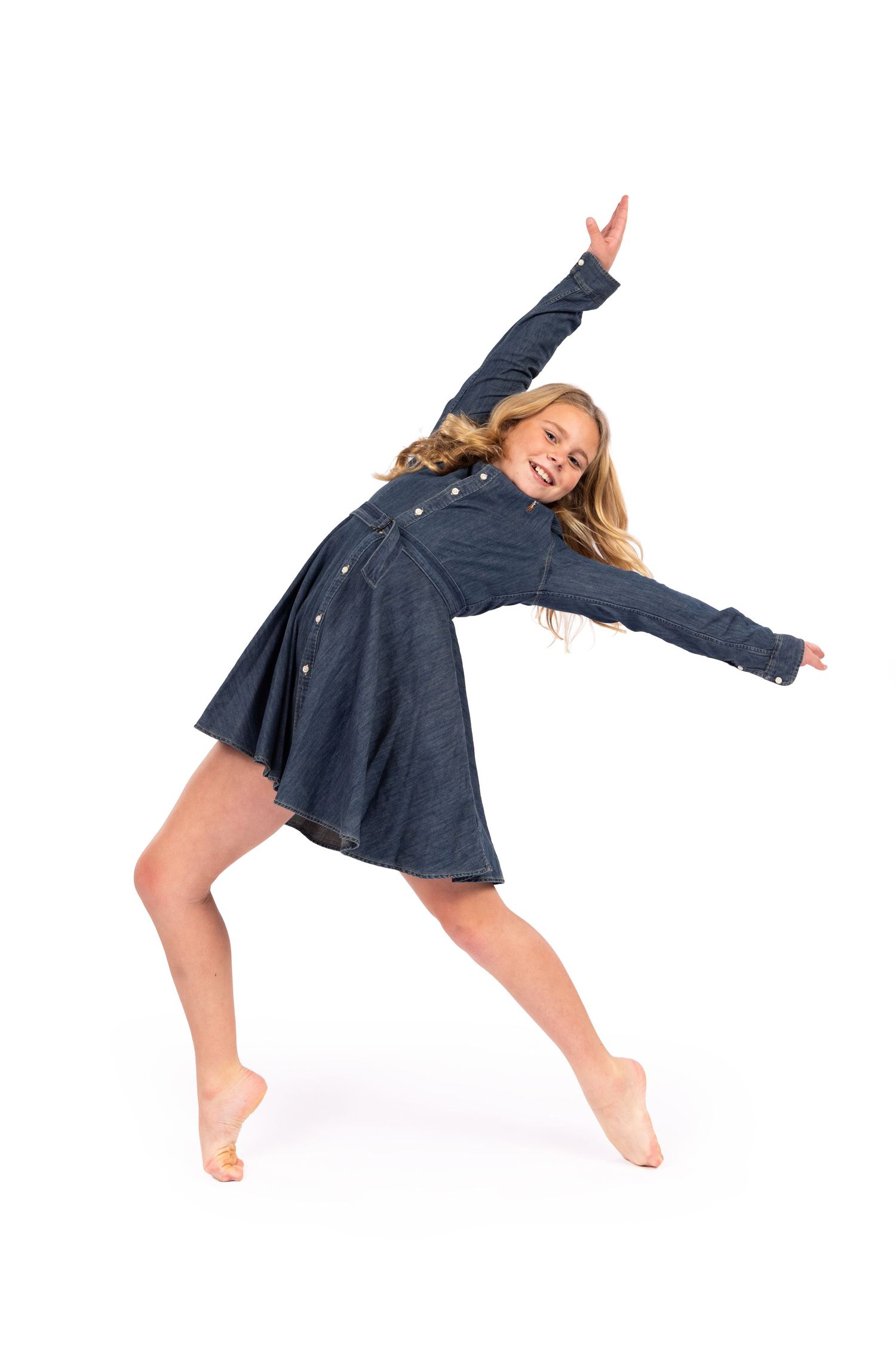 A dancer in a navy dress performs a graceful falling sequence showing movement progression from right to left.