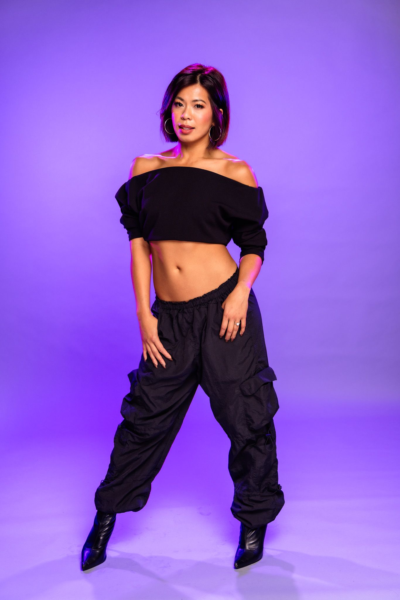 Fashion model poses in black outfit against purple backdrop showing various dynamic dance-inspired movements.