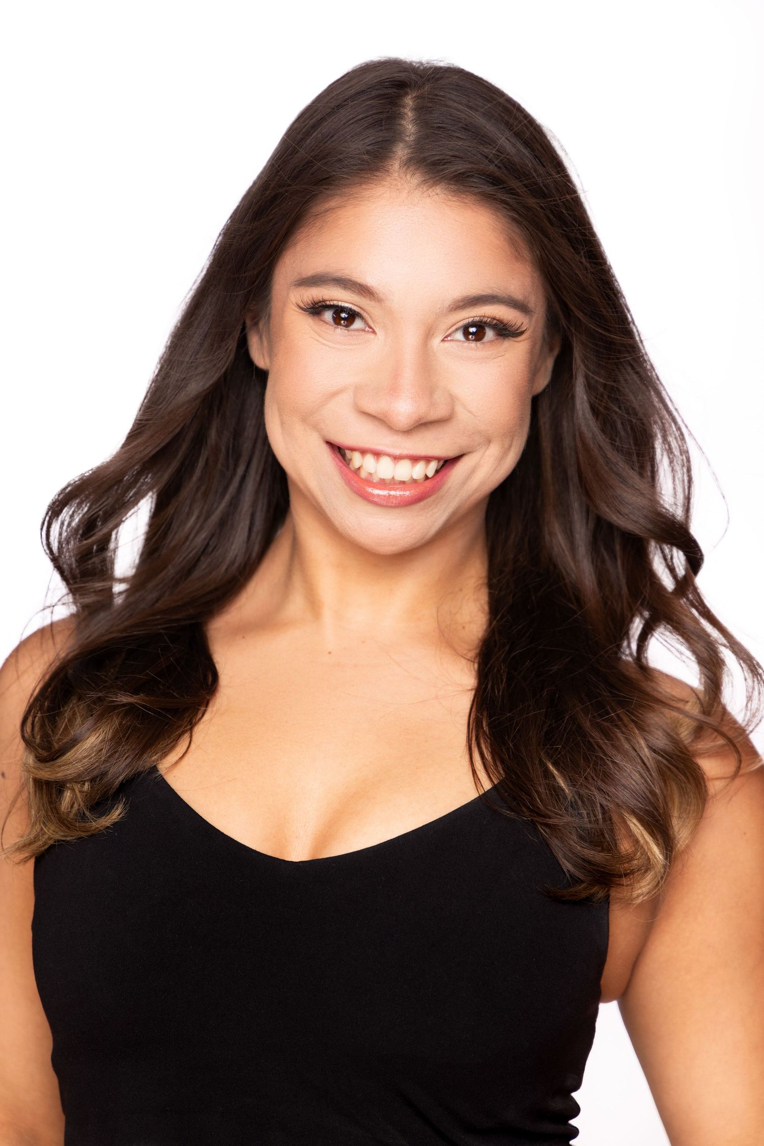 Professional headshots against white background wearing black top with flowing dark hair.
