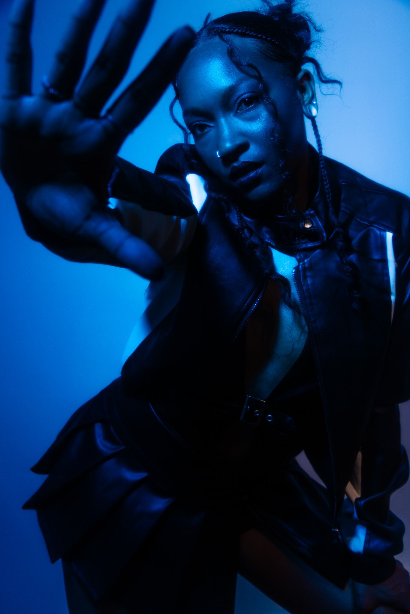 Artistic portrait sequence showing silhouetted figure in dramatic blue lighting creating dynamic poses against dark background.