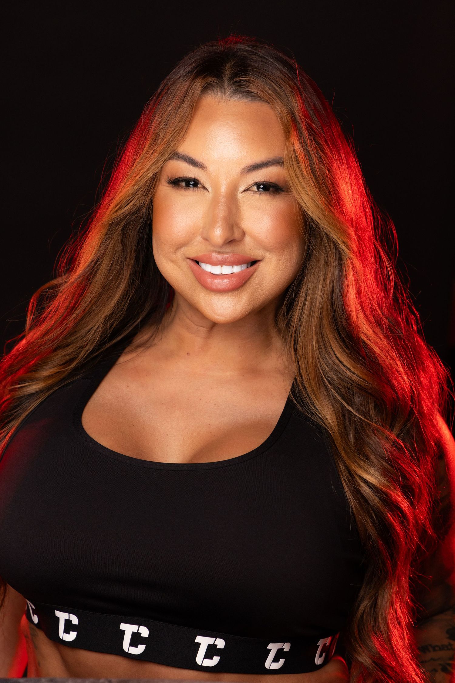 Professional headshot portraits against dark background with dramatic red lighting and black attire.