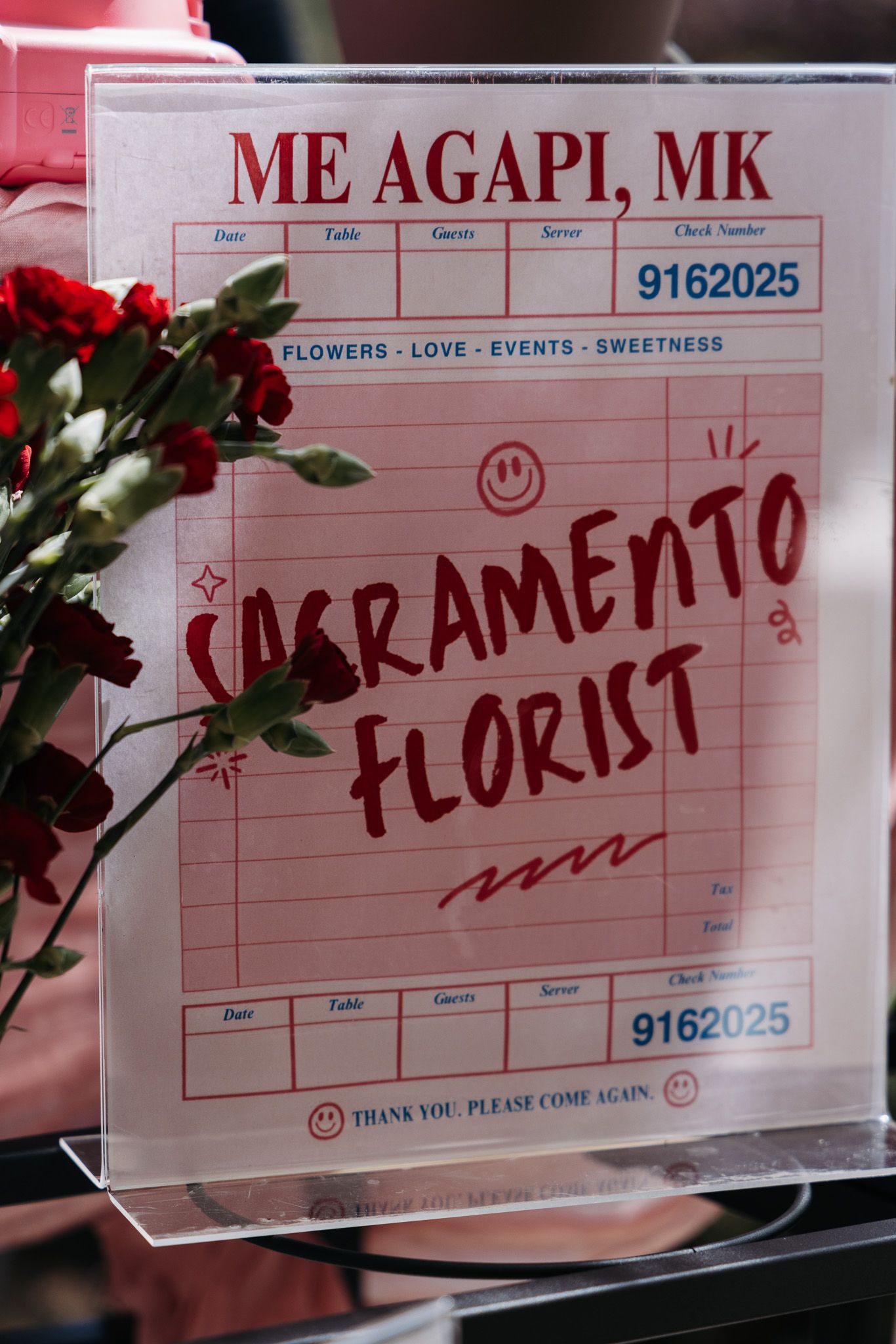 Receipt or order forms from Me Agapi MK flower shop with handwritten text in red.