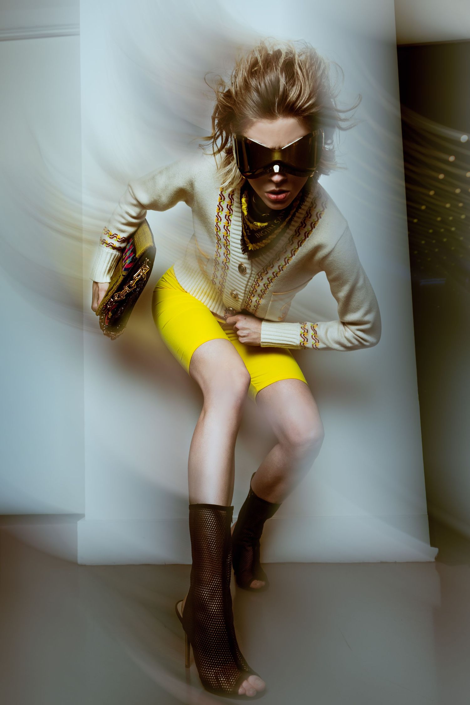 Artistic fashion photo series featuring yellow skirt and boots in moody lighting.