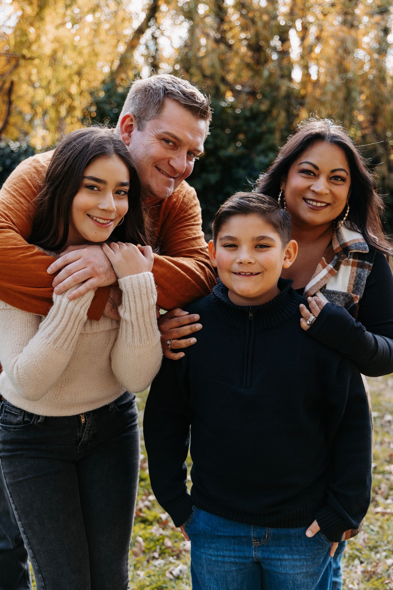 A playful family photoshoot sequence showing candid moments and laughter in an autumn outdoor setting.