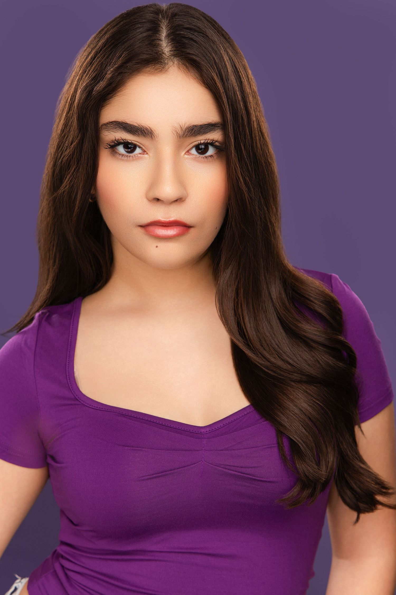 Fashion portrait sequence featuring a purple sweetheart neckline top against violet backdrop.