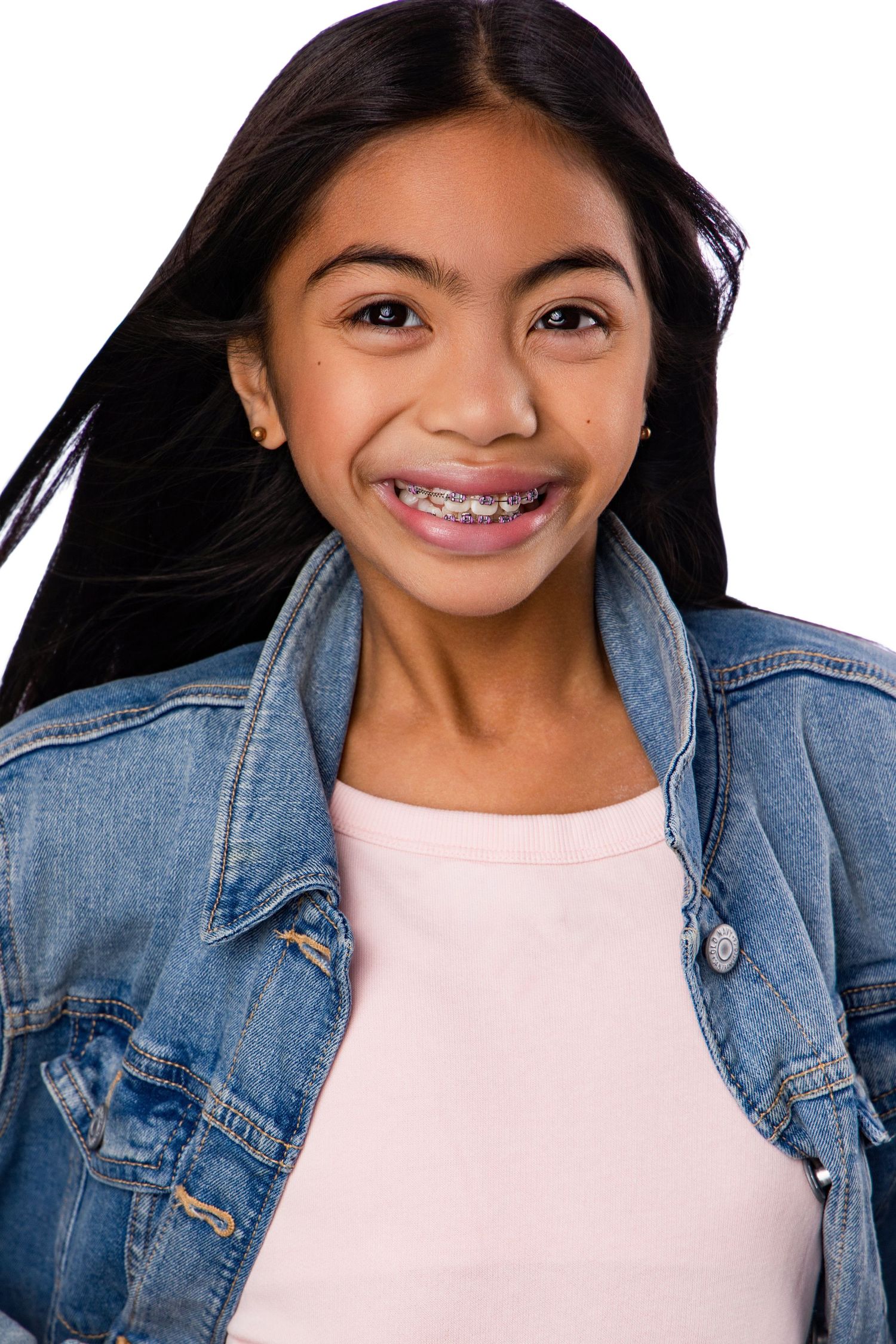 Young person wearing a denim jacket and pink top smiles brightly in a series of four casual portrait photos.