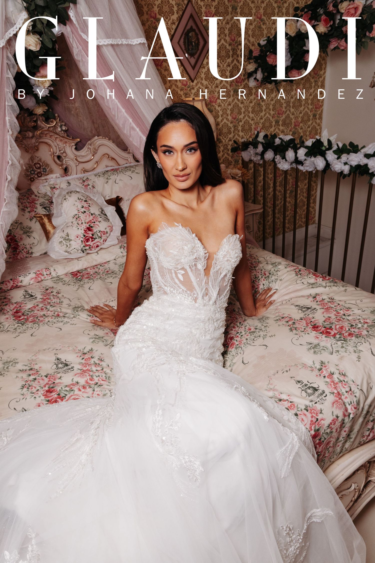 Model wearing a Glaudi by Johana Hernandez strapless lace mermaid wedding gown while seated on a floral bed.