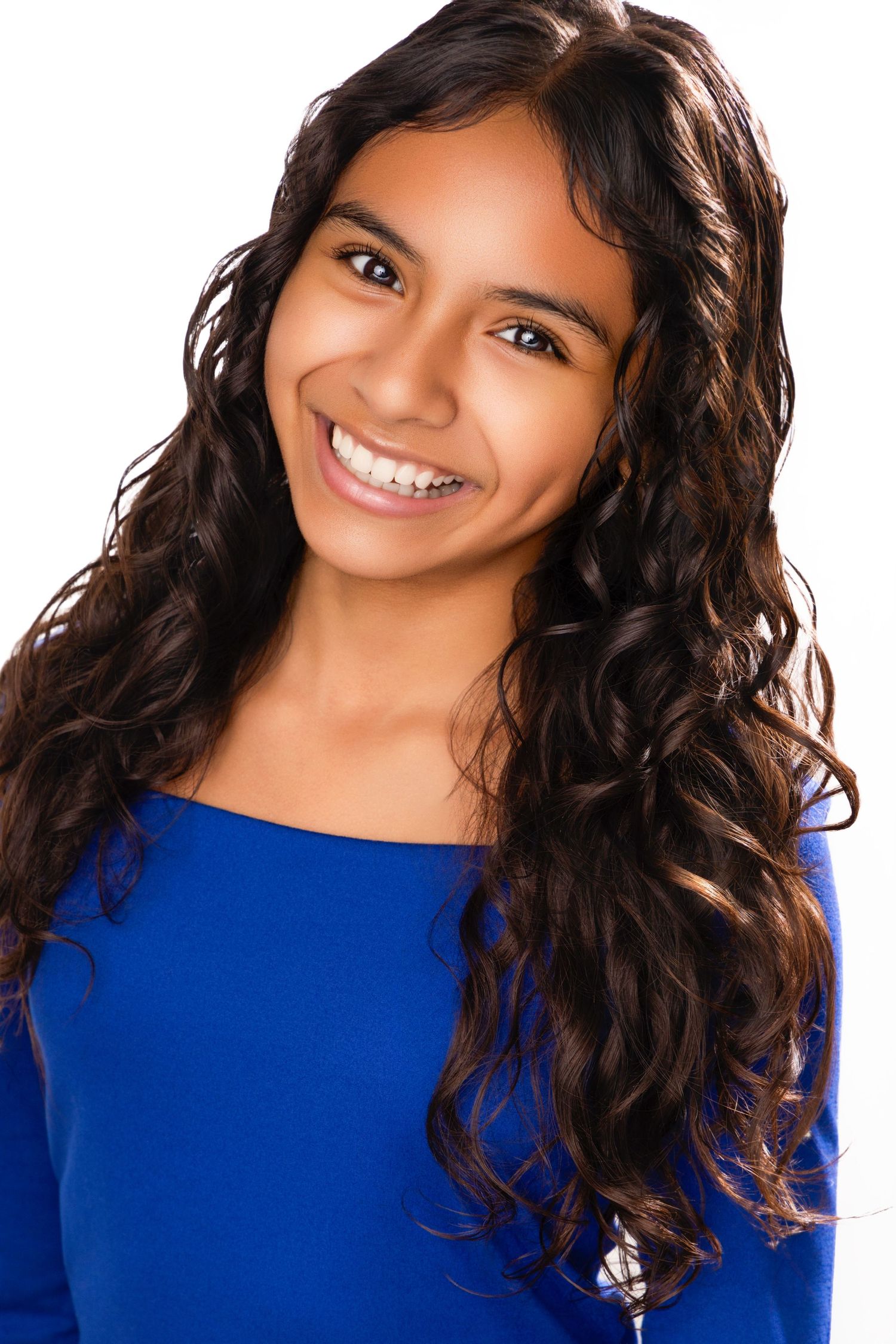 A series of five headshots showing a person with curly dark hair wearing a royal blue top against a light background.