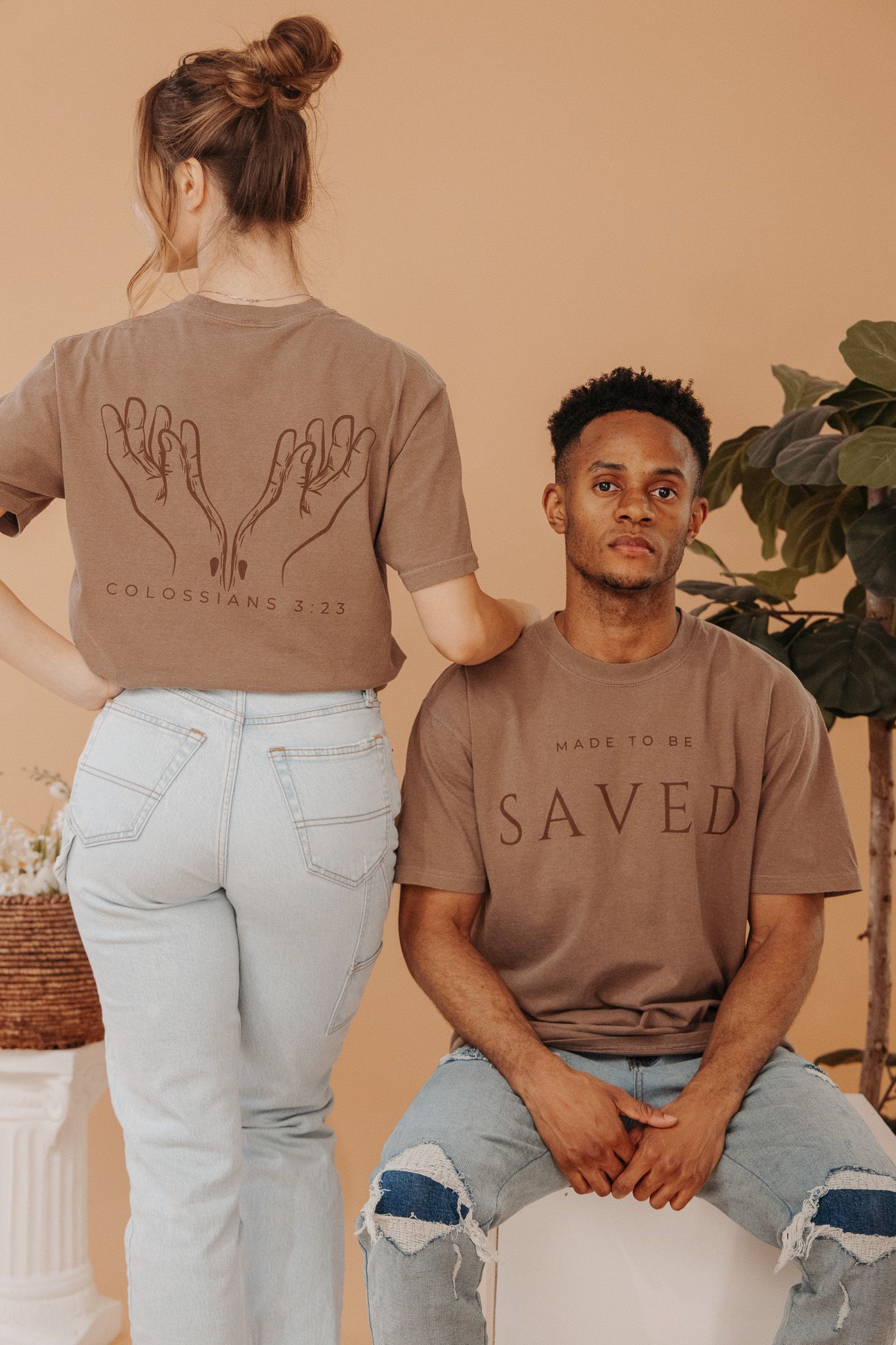 Models wearing light brown Christian t-shirts showcasing religious faith-inspired casual apparel designs.
