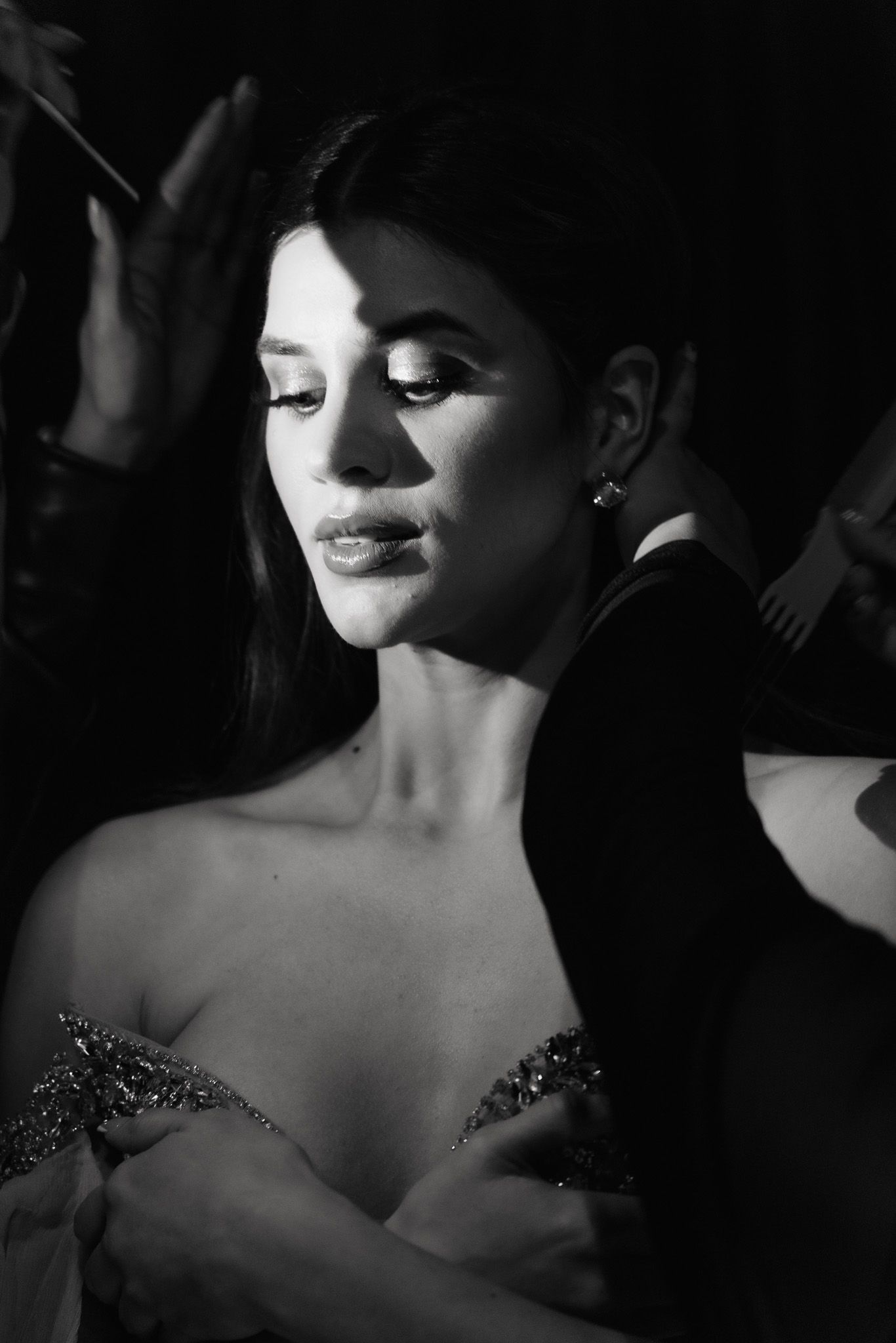 Dramatic black and white photo series showing close-up details of a woman in an elegant beaded evening gown.