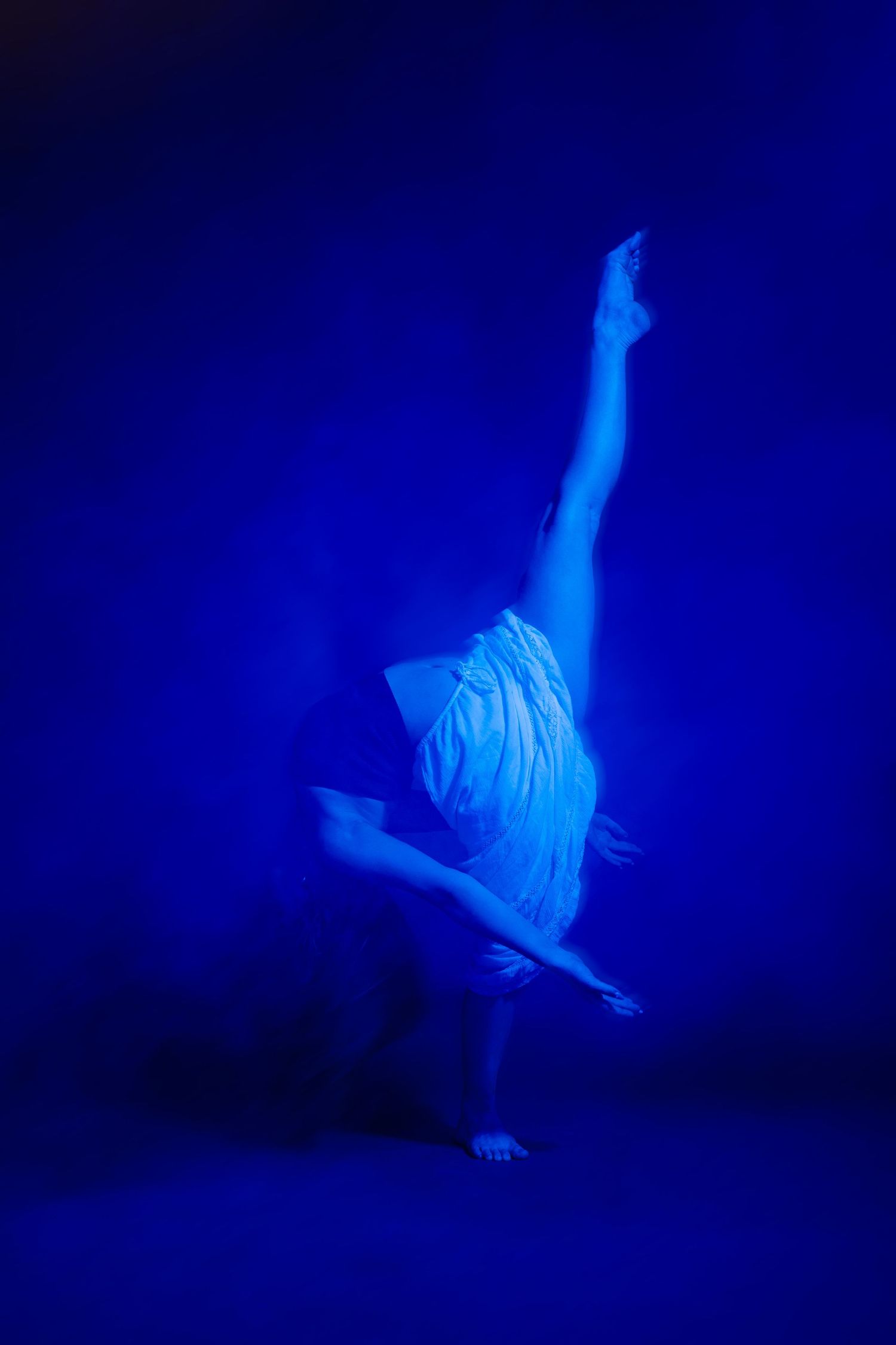 Artistic dance performance sequence showing fluid motion in ethereal blue lighting against dark background.