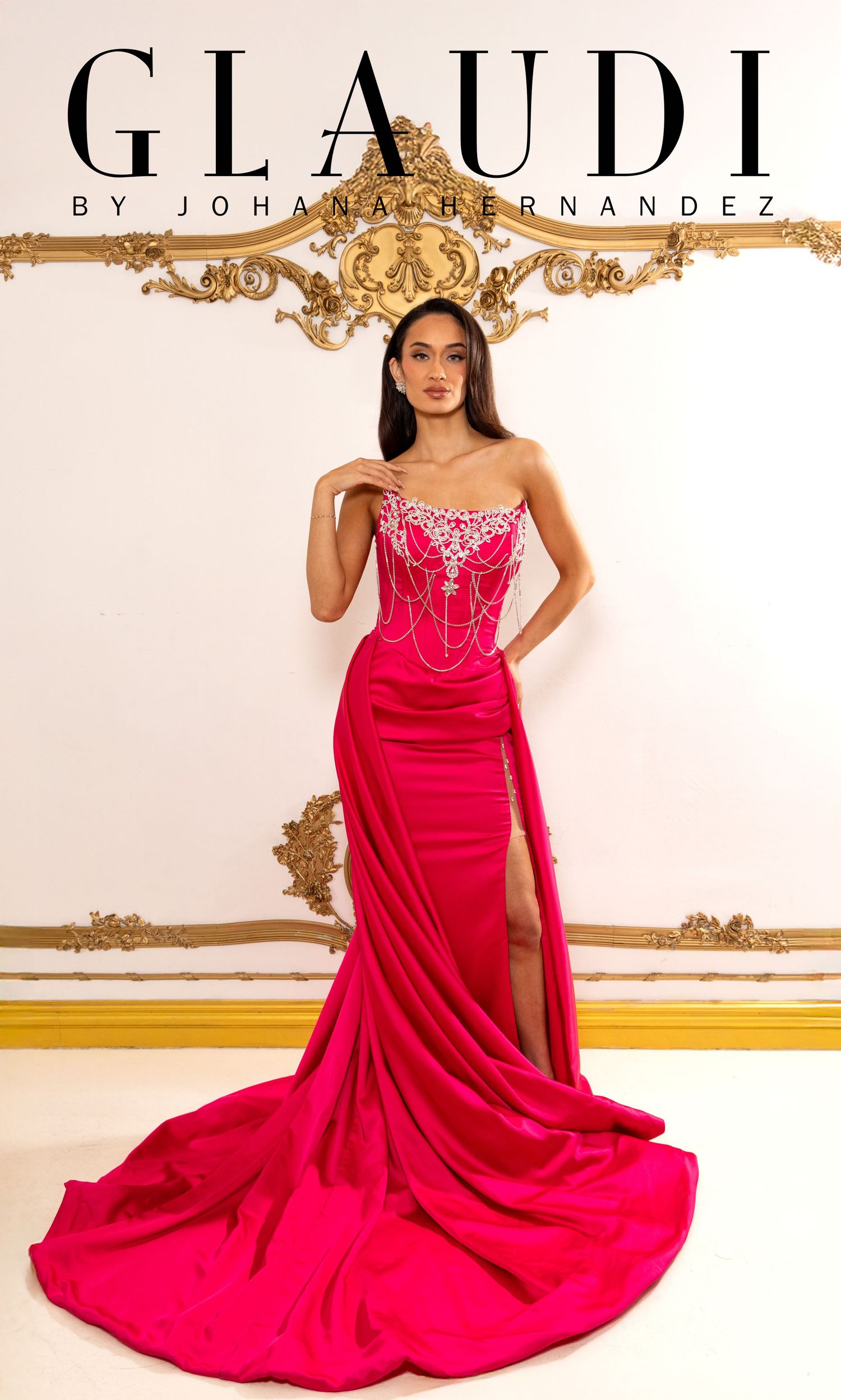 Model wearing a hot pink strapless gown with crystal embellishments and a side slit by Glaudi by Johana Hernandez.