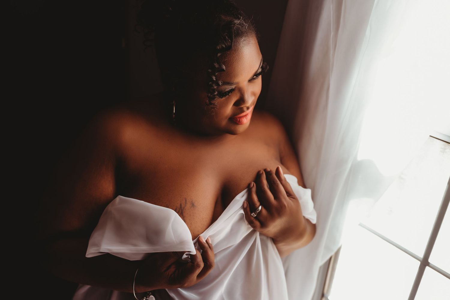 Intimate getting ready moments captured in soft window light.