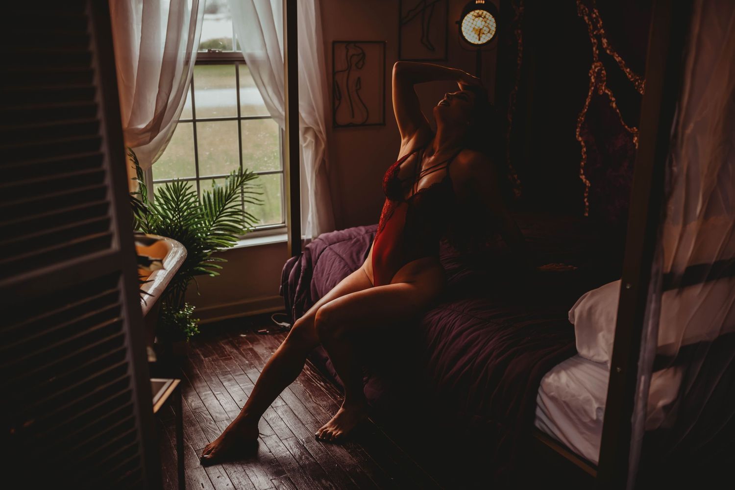 A cinematic sequence showing a person and dog sitting in the dark ambiance of a room near a window.