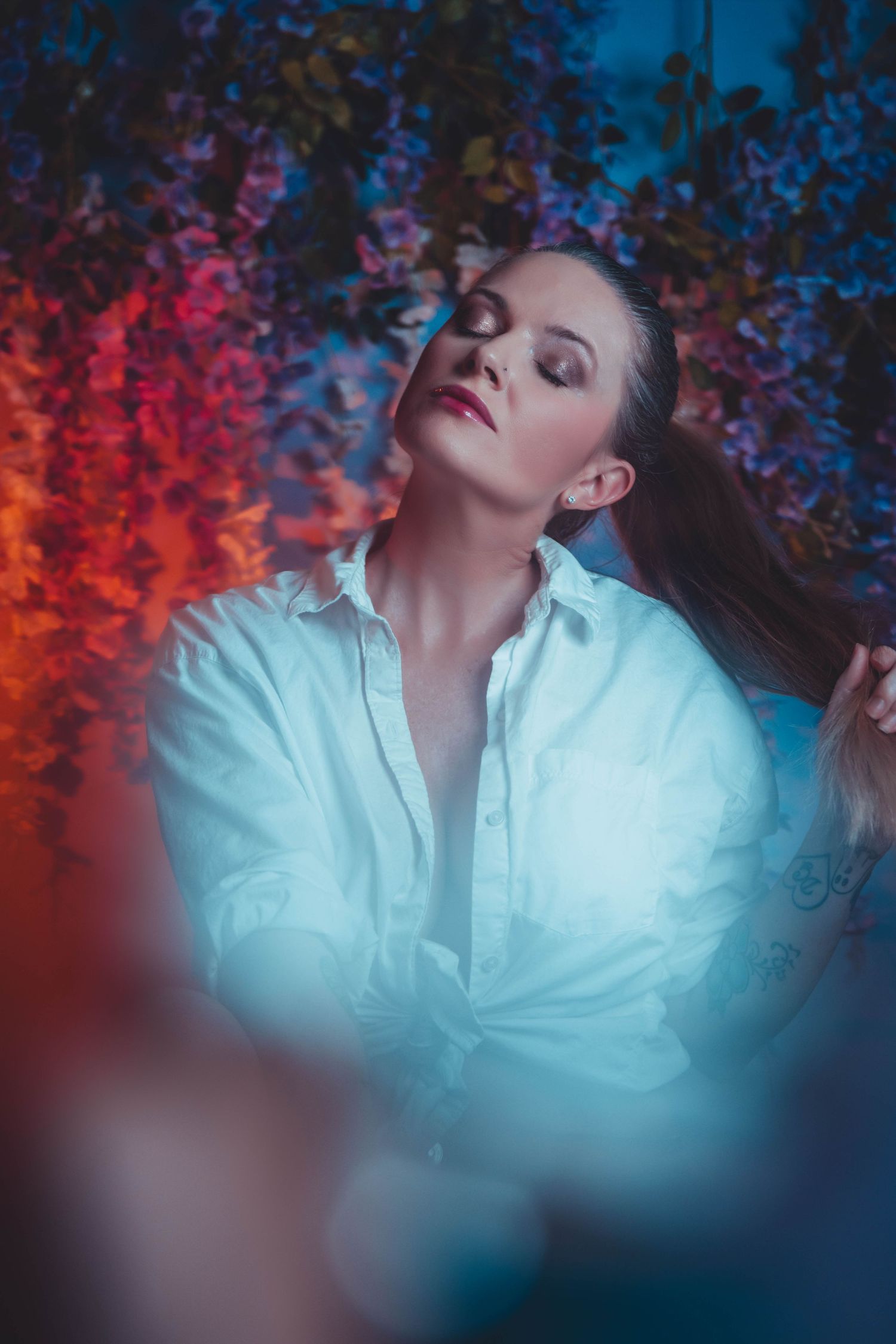 Artistic portrait series against blue and red gradient background with moody lighting and expressive poses.