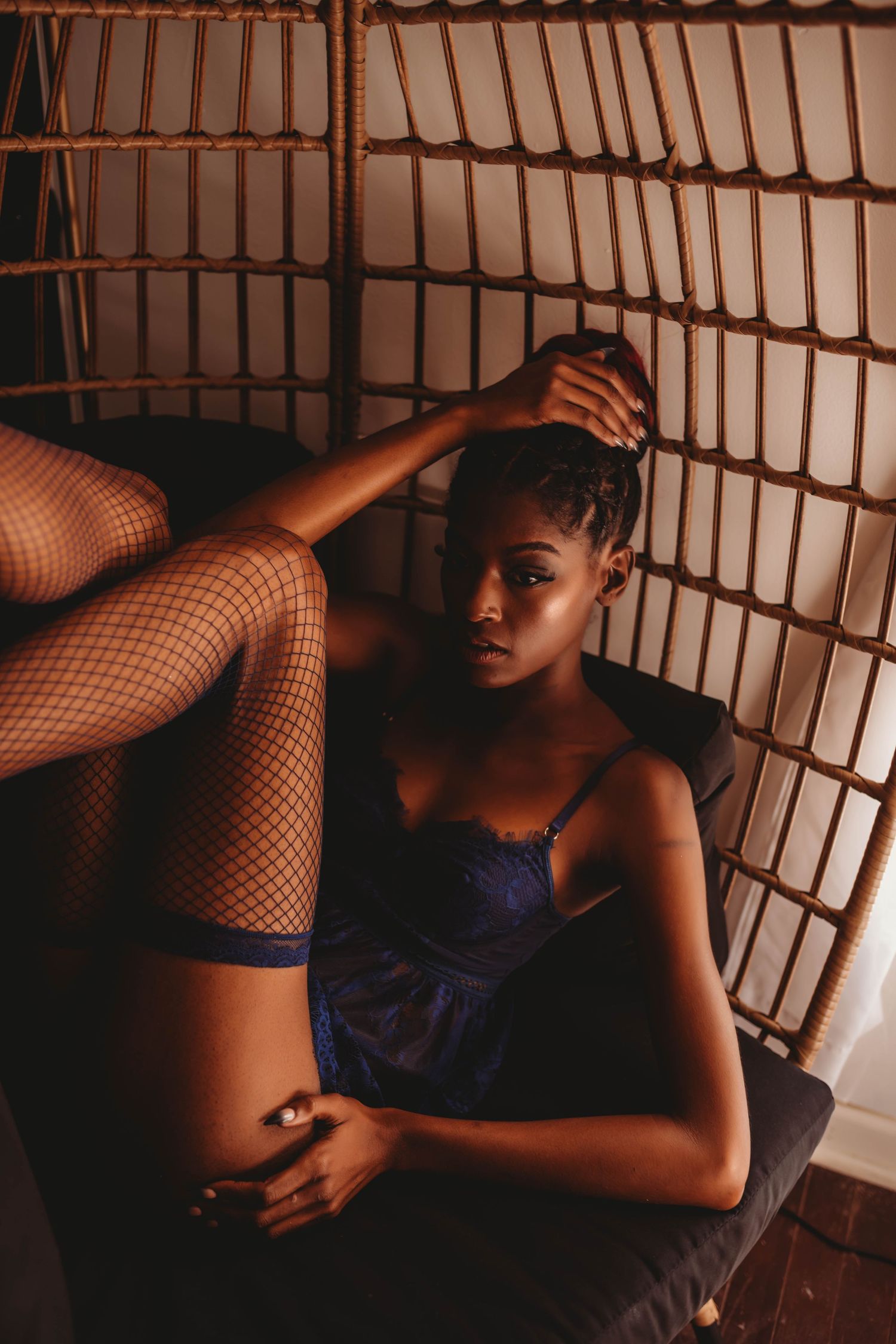 Artistic portrait in blue lingerie with dramatic lighting and grid pattern shadows.
