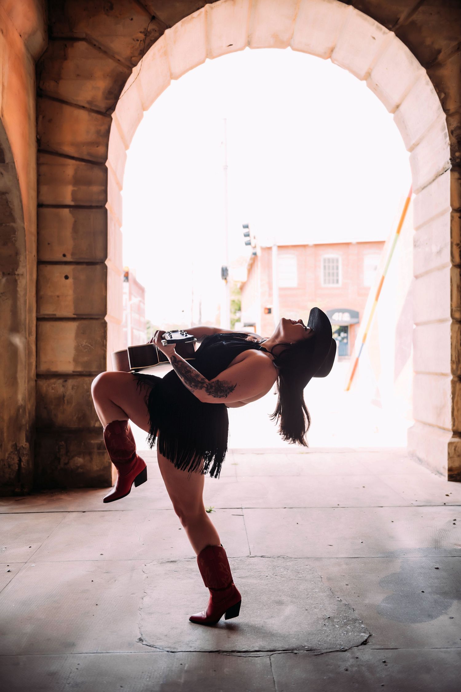 Dynamic dance sequence captured under a stone archway showing flowing movement.