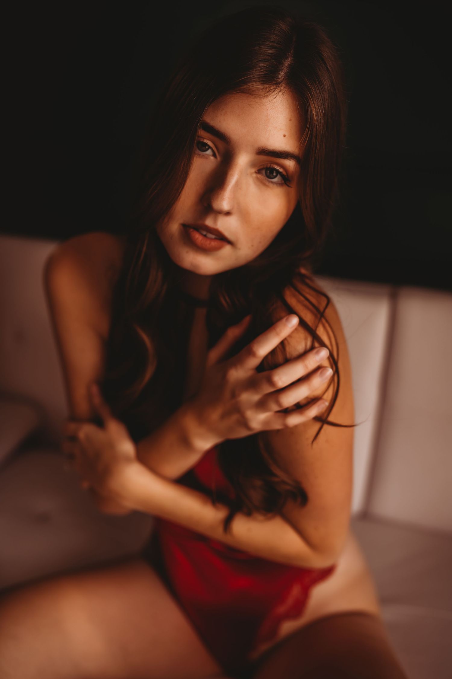Sensual close-up portrait with warm tones and soft lighting.