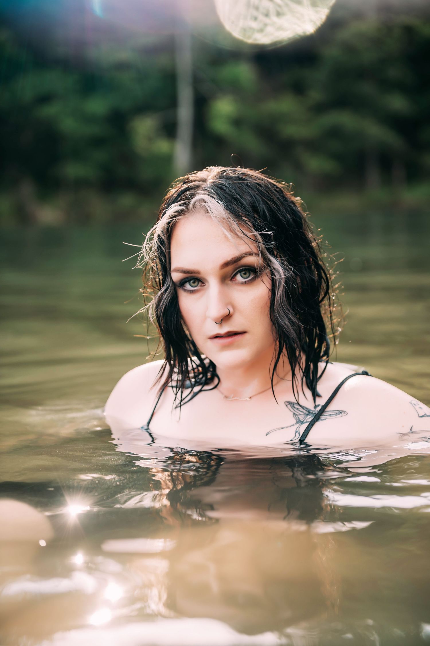 Artistic water portrait in natural light with soft bokeh effects.