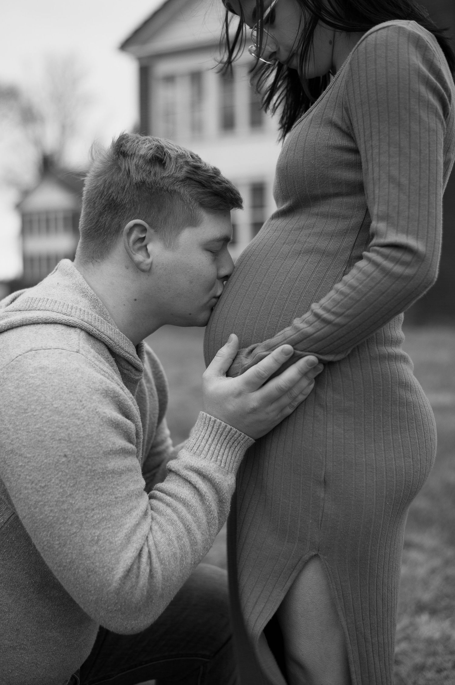 Black and white maternity photos showing tender moments between expecting parents.
