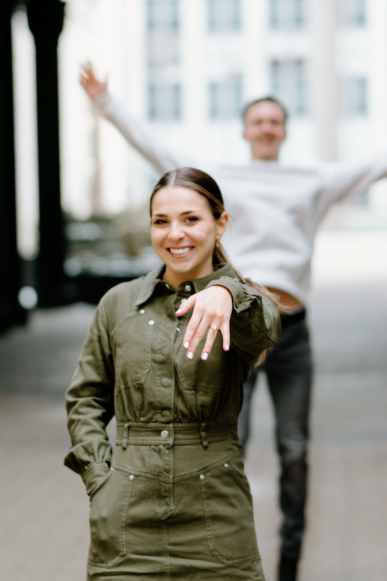 Joyful engagement photo sequence showing woman celebrating while wearing olive green jumpsuit.