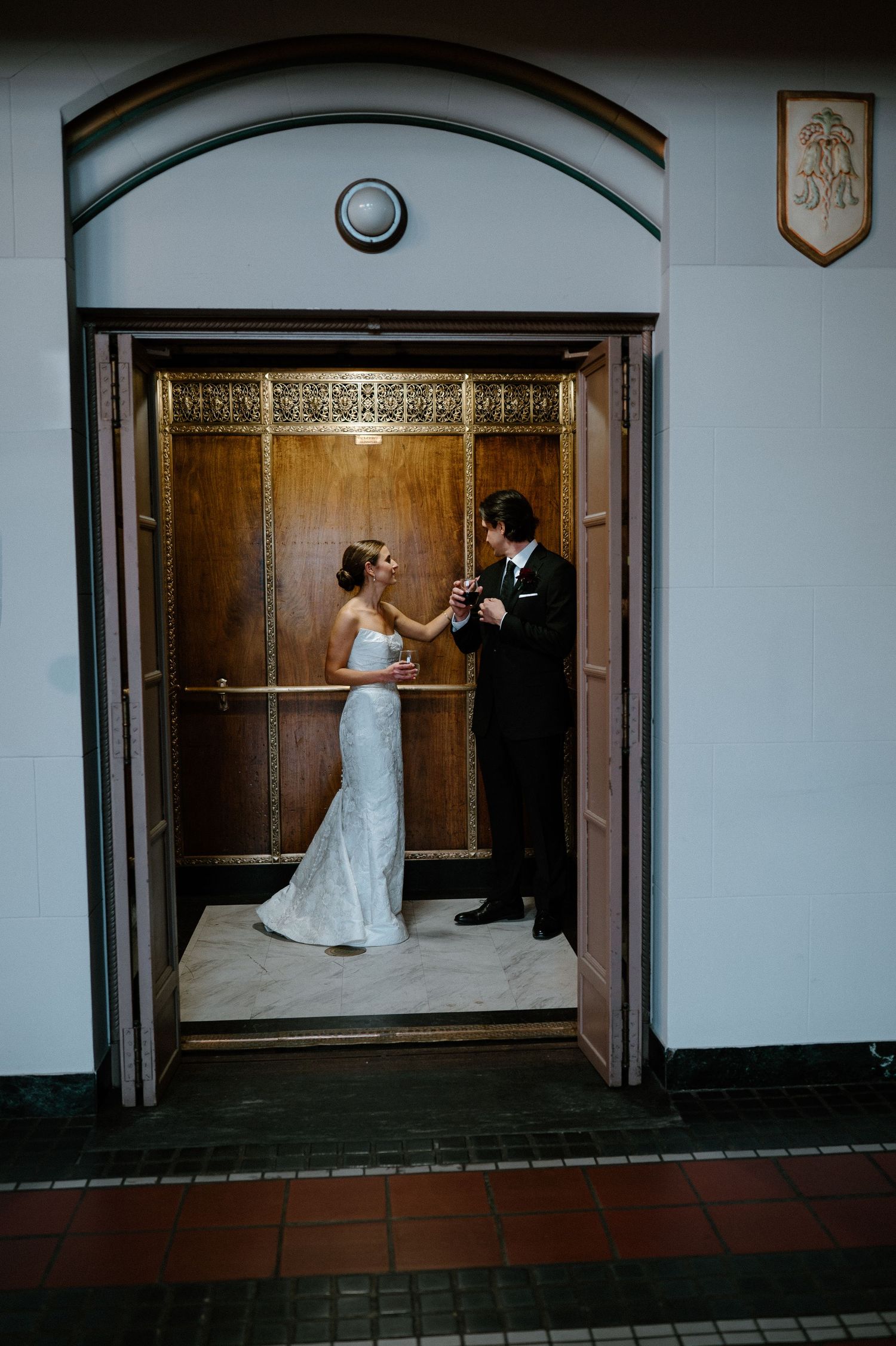 A sequence of wedding photos showing a couple in formal attire interacting near an elegant wooden doorway.