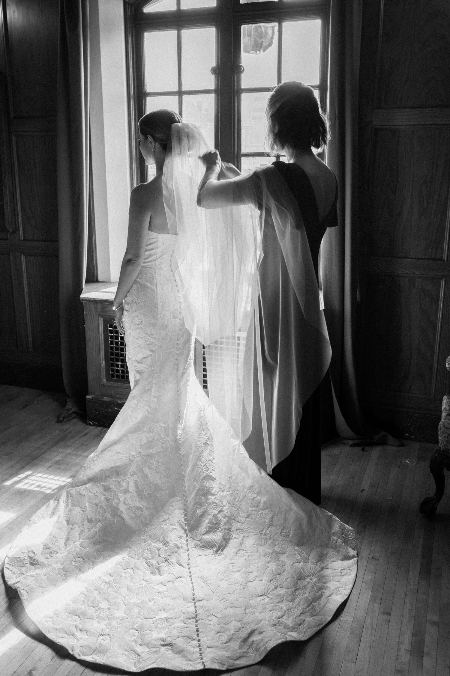A series of wedding dress photos showing the intricate lace train and veil details in a sunlit room.