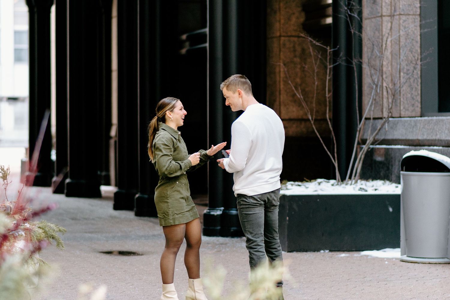 Candid outdoor proposal sequence showing different moments between couple.