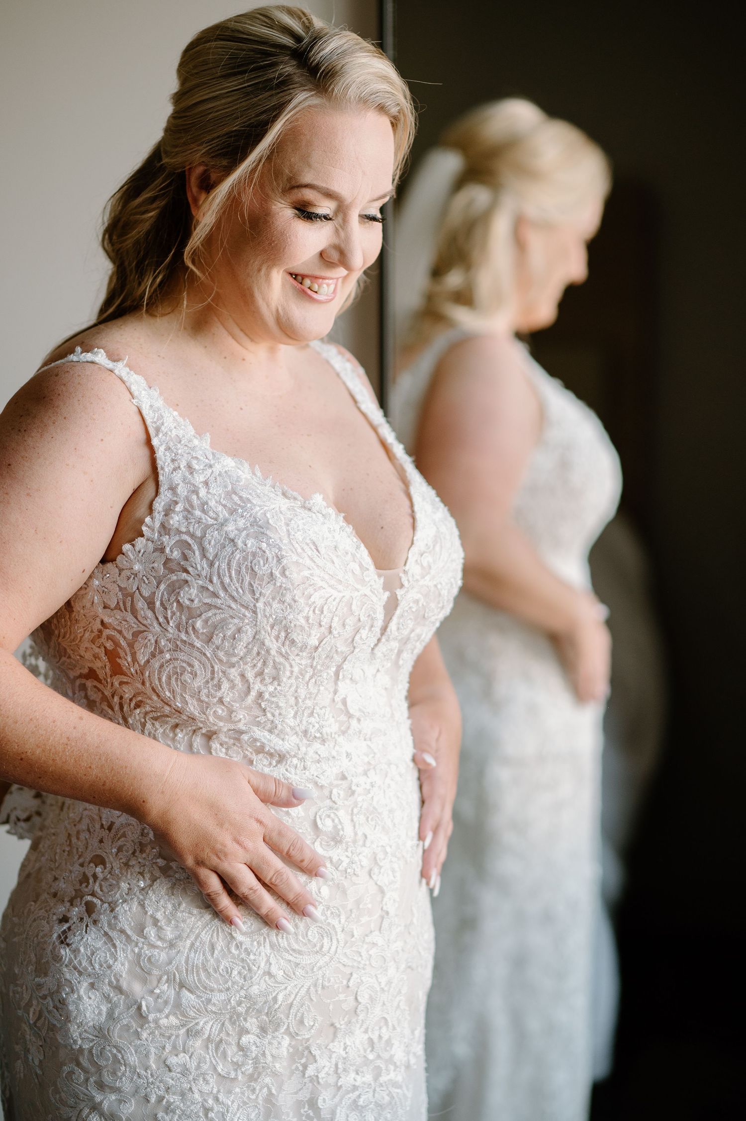 Close-up view of detailed lace wedding dress with elegant floral patterns.
