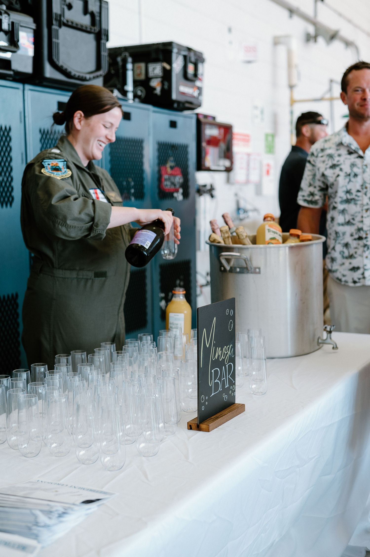 Bar setup with rows of empty glasses ready for event service.