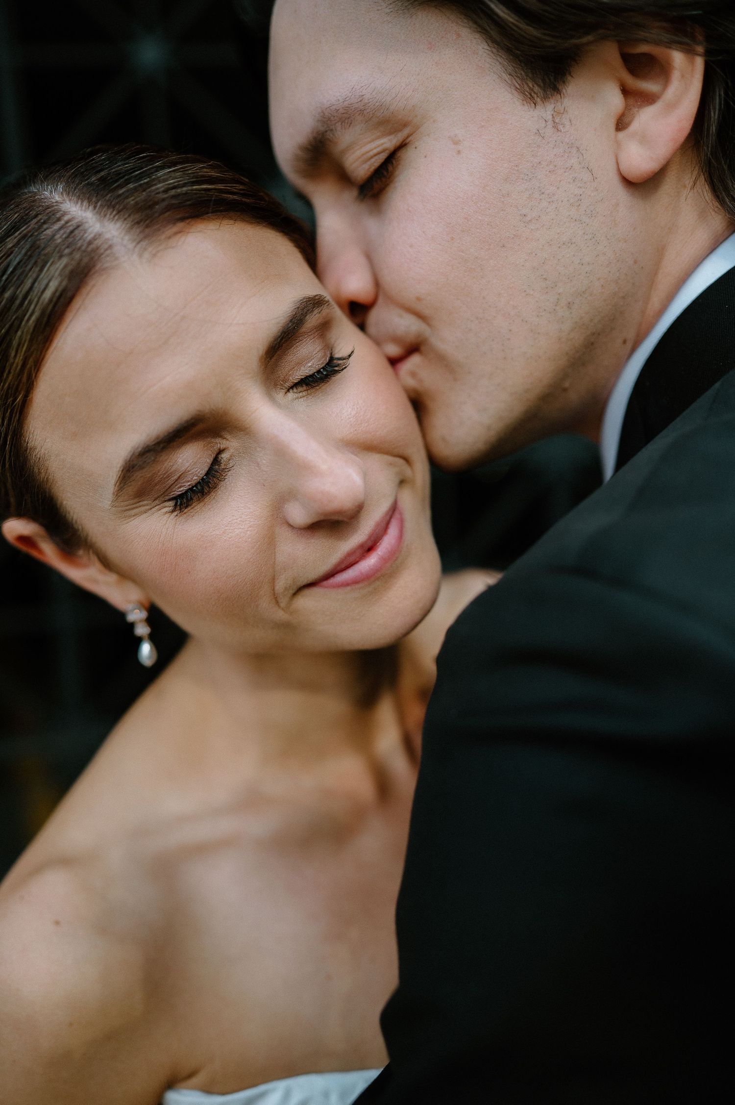 Romantic black and white close-up photos of a couple sharing intimate moments and tender kisses.