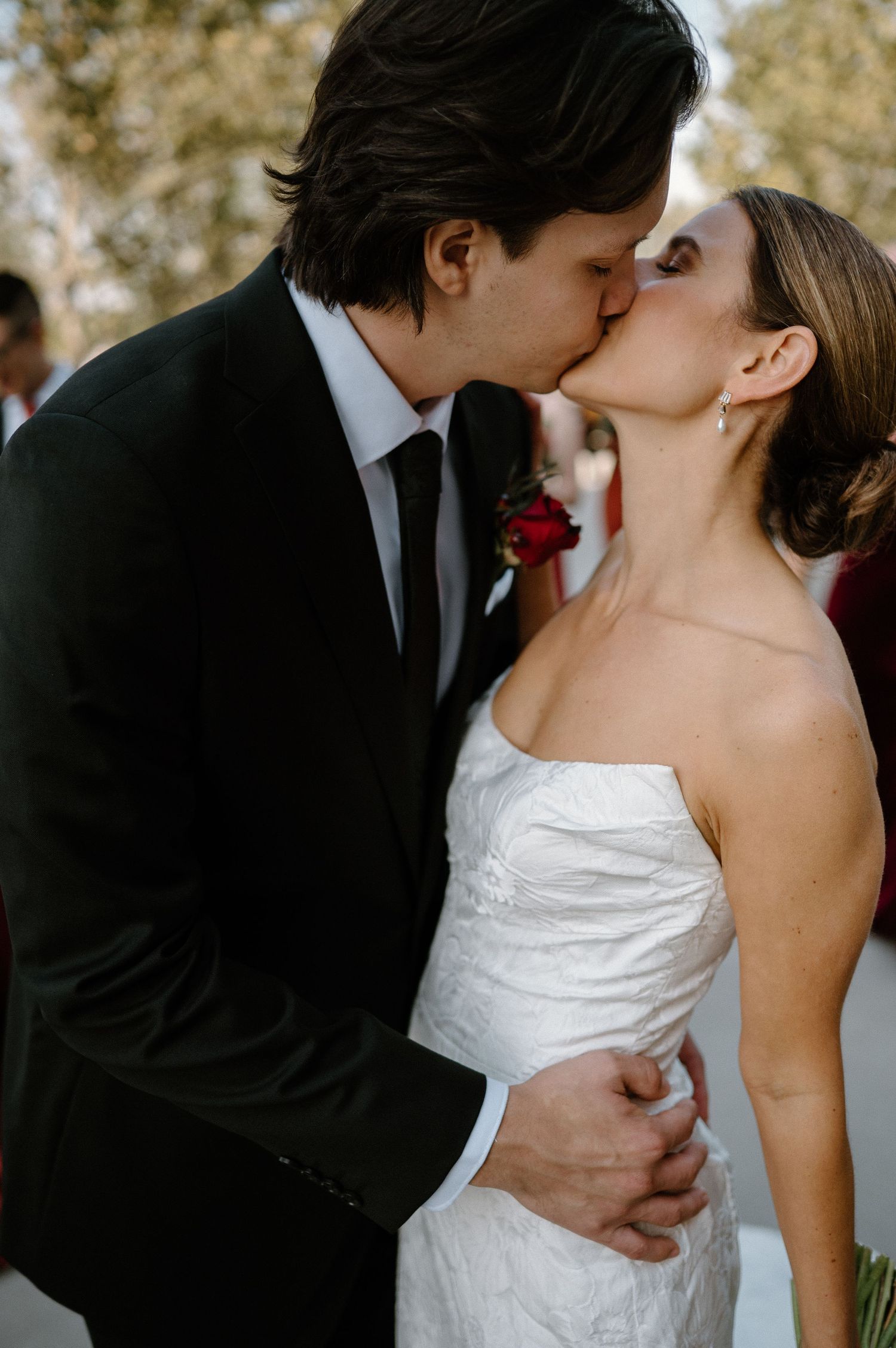 A romantic wedding kiss sequence showing five progressive moments of a couple sharing their first kiss as newlyweds.