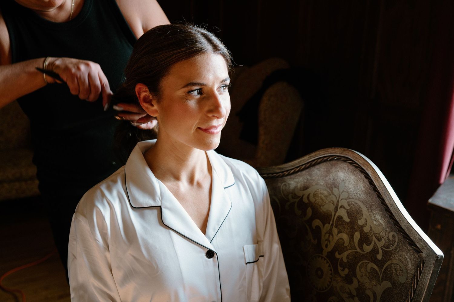 A person in a white chef's coat stands in a dimly lit restaurant kitchen.