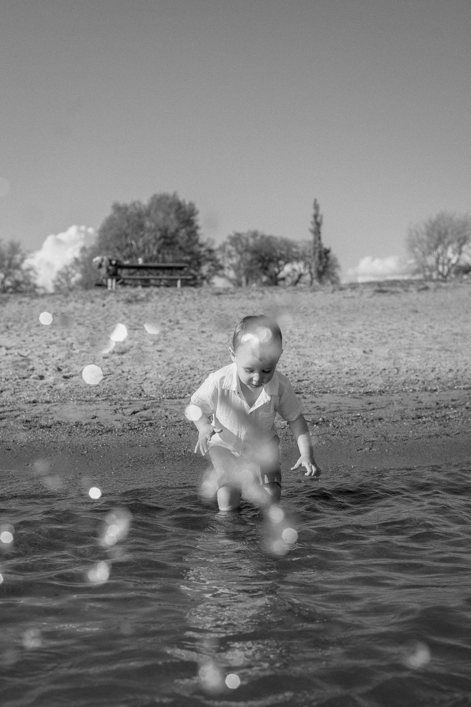 Black and white series of splashing and playing in beach water.