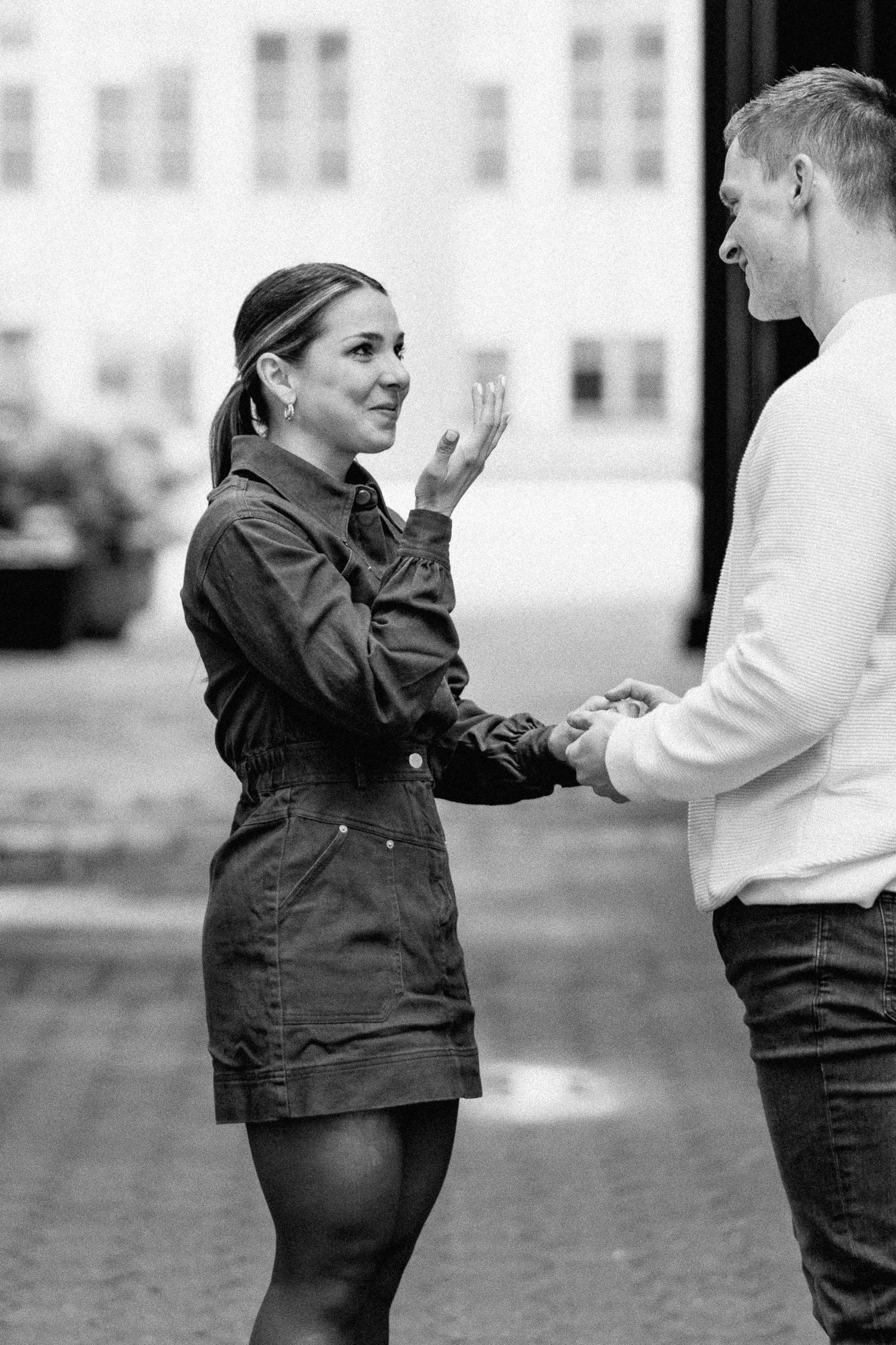 Black and white sequence capturing surprise proposal reactions between two people.