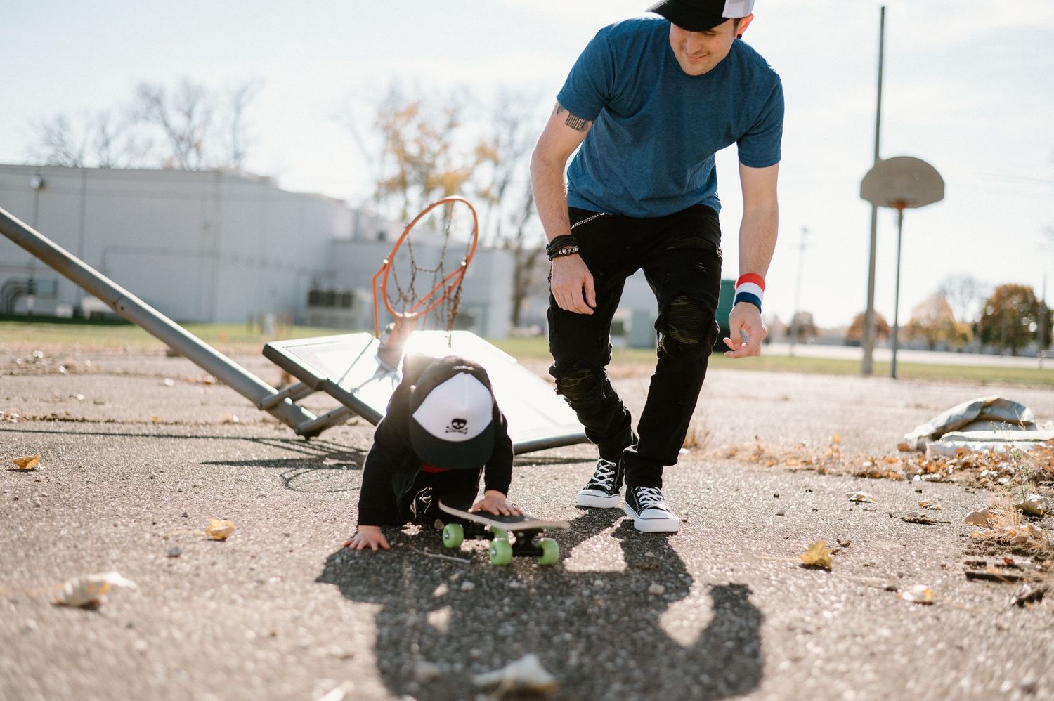 Skateboarder performing tricks in an urban setting at sunset.