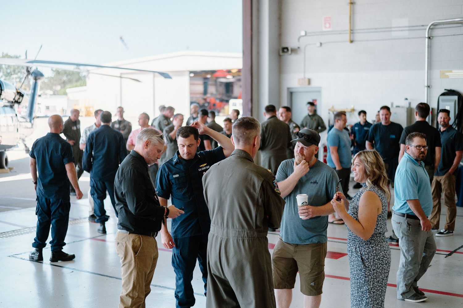Reception hall filled with guests mingling during social event.