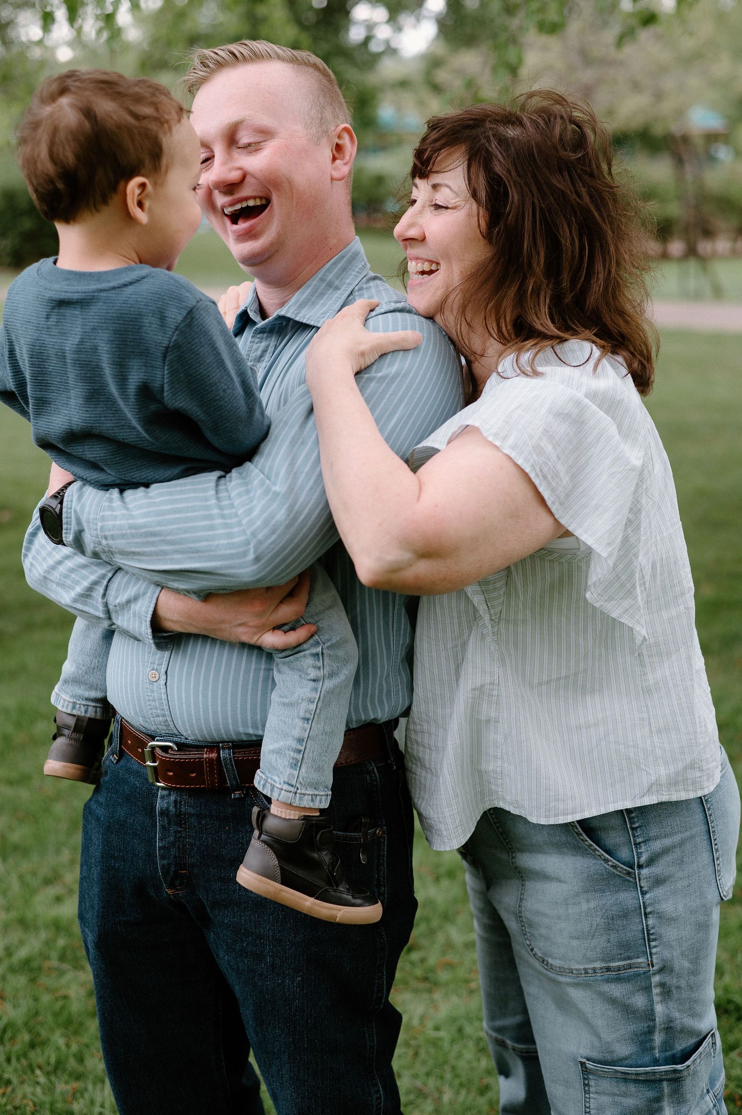 A happy family shares laughter and embraces while enjoying time outdoors.
