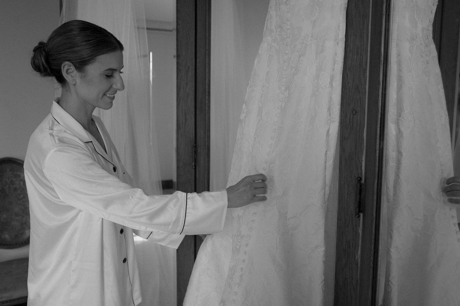 Medical professionals in white lab coats examine and discuss documents in a clinical setting.