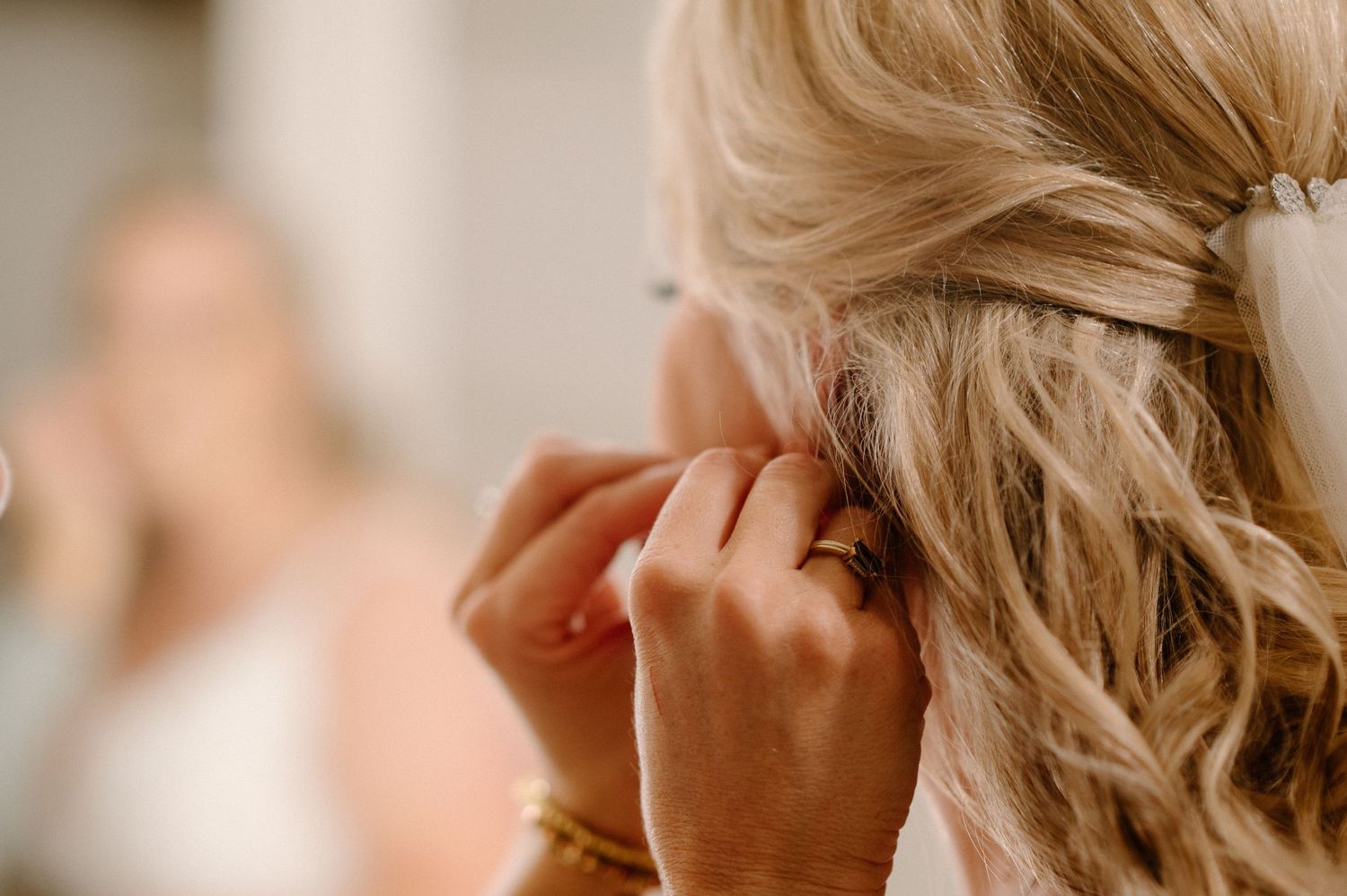 Close-up of intricate bridal hairstyling with soft waves and delicate details.