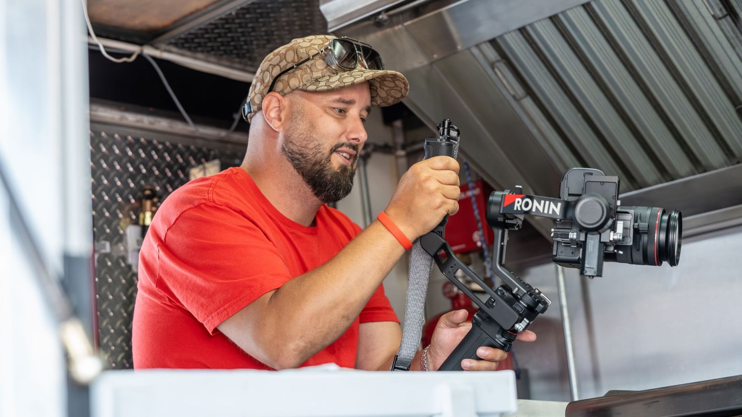 Professional photographer capturing event moments in a commercial kitchen setting.