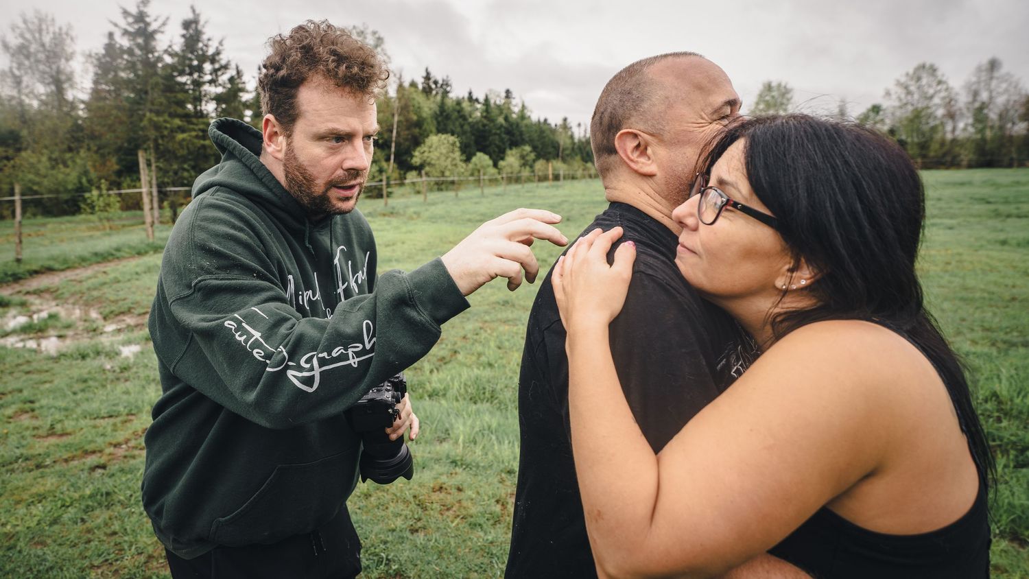 Photography session taking place in a green outdoor setting.